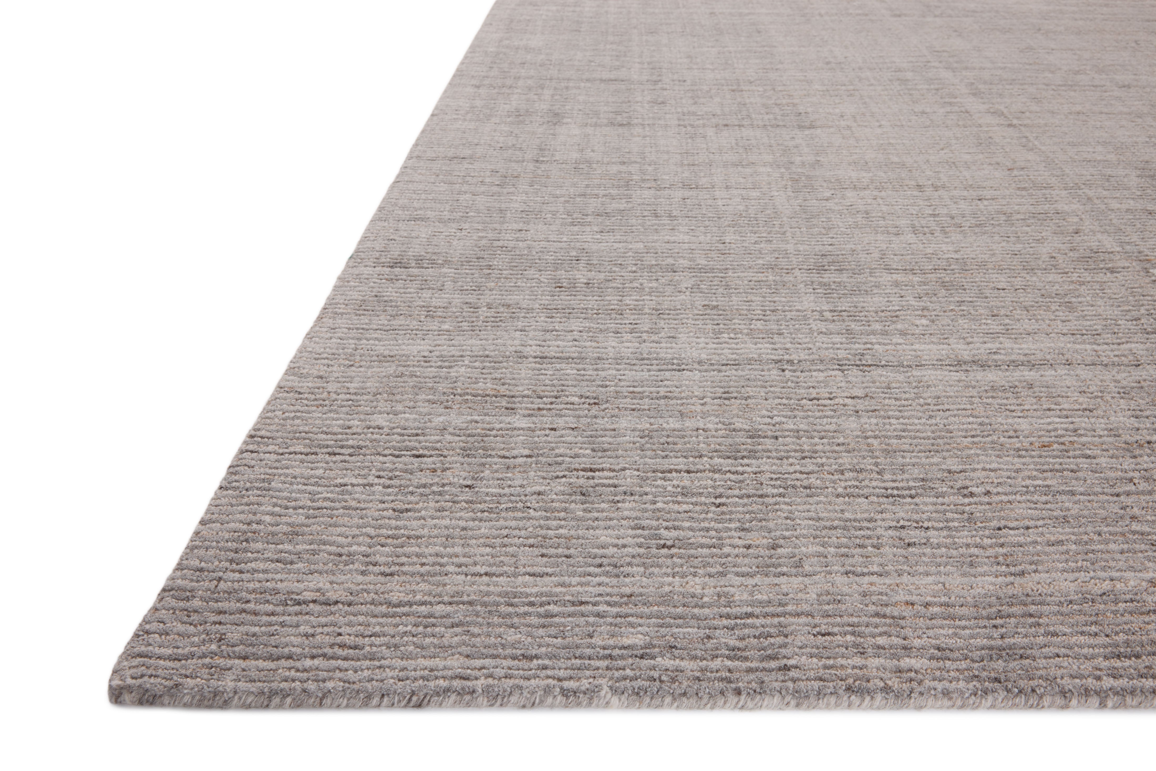 The Thorne THT-01 Grey Area Rug delivers elegant grey beauty in a hand-loomed polyester area rug