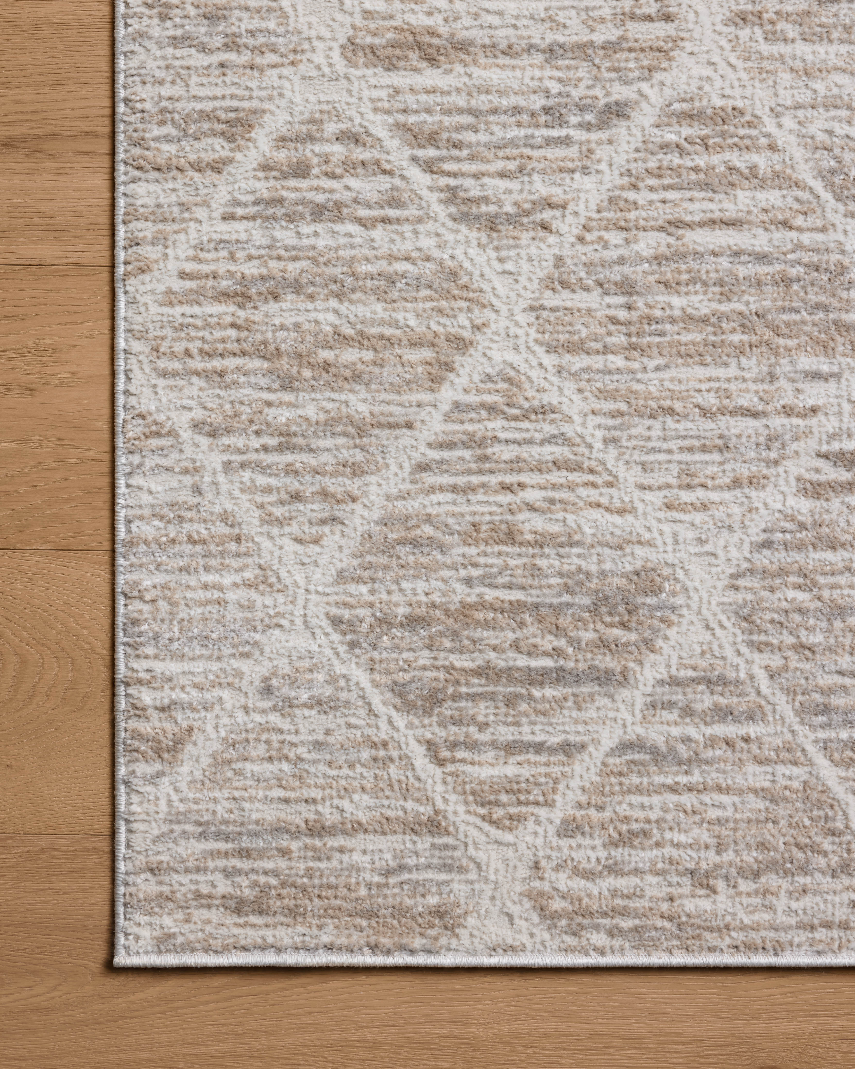 A stunning power-loomed polyester area rug with abstract detail, the Townes TOW-01 Pebble / Beige Area Rug features subtle pebble and warm beige tones for a polished look
