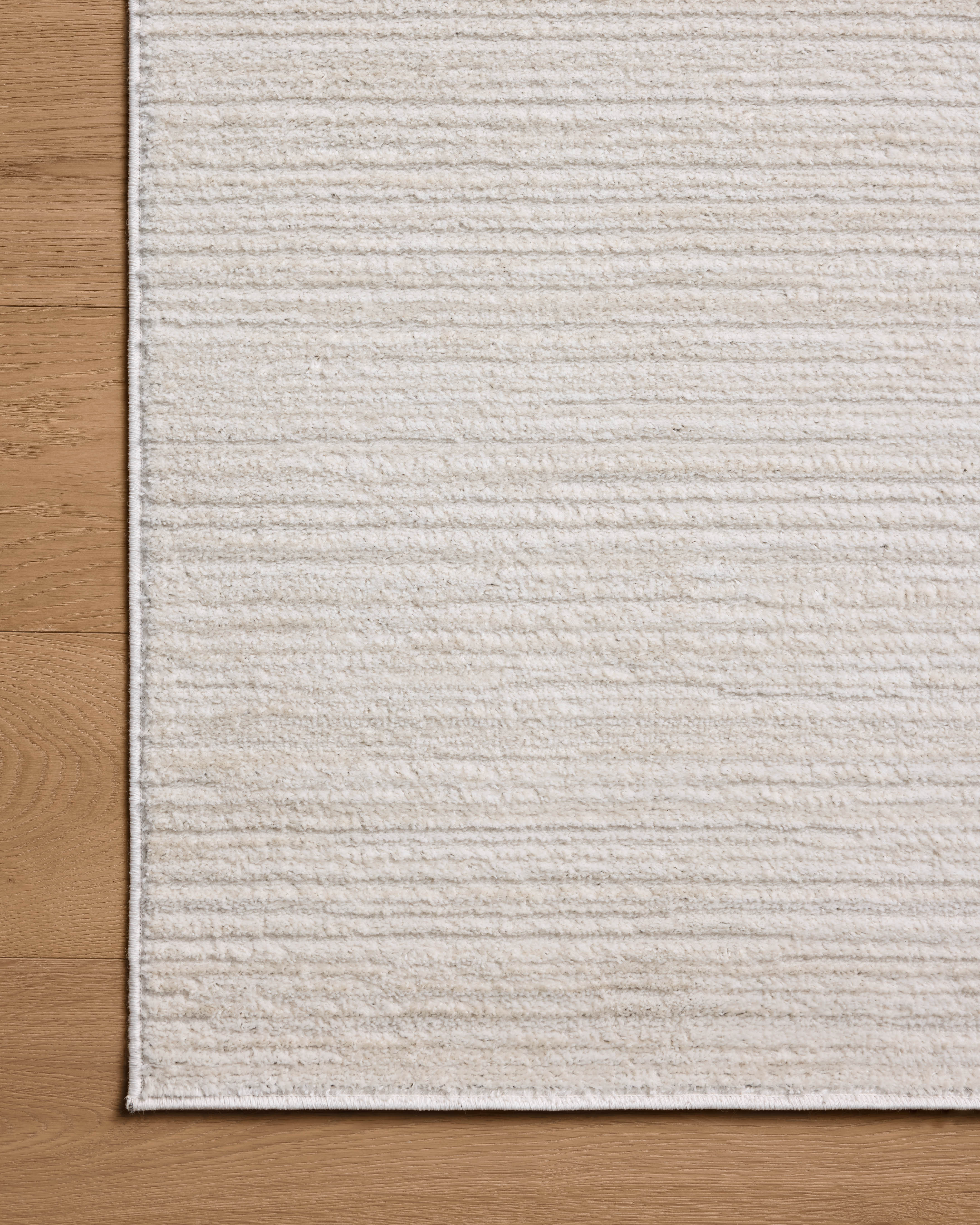 The Townes TOW-02 Beige / Ivory Area Rug delivers warm beige and refined ivory beauty and abstract elegance in a power-loomed polyester area rug