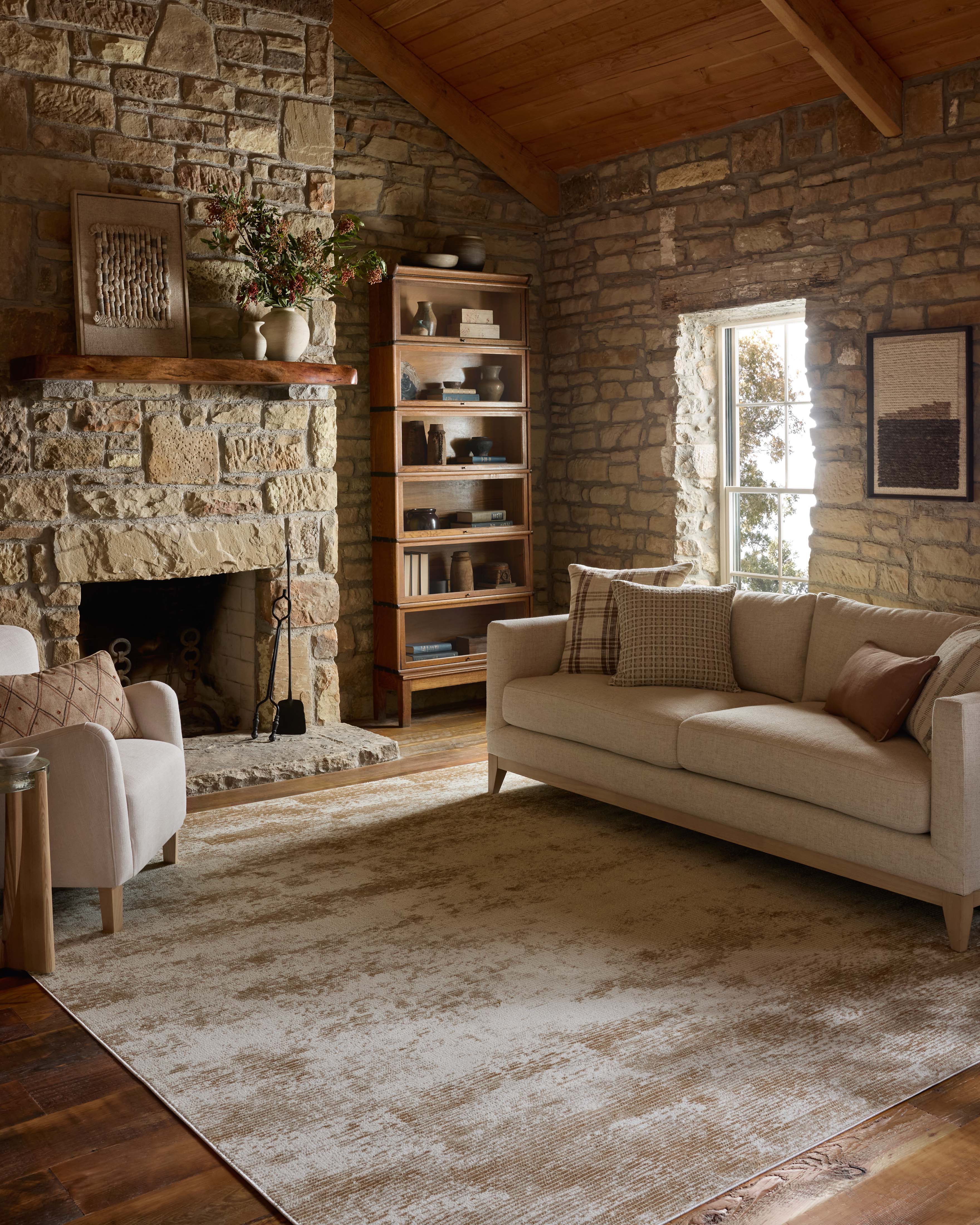 Designed with abstract artistry in sandy and warm beige hues, the Townes TOW-03 Sand / Beige Area Rug is a power-loomed polyester area rug that stands out