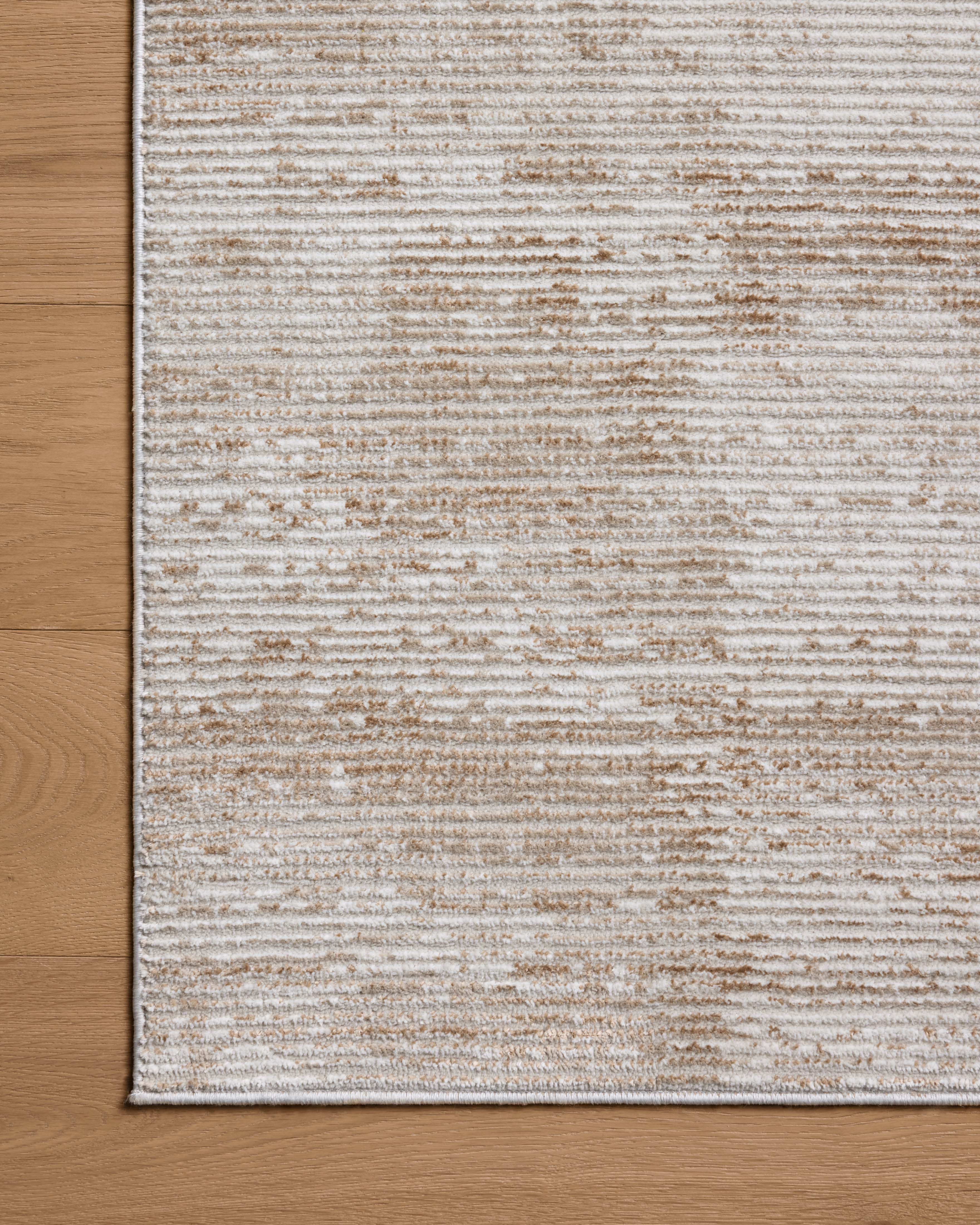 Designed with abstract artistry in sandy and warm beige hues, the Townes TOW-03 Sand / Beige Area Rug is a power-loomed polyester area rug that stands out
