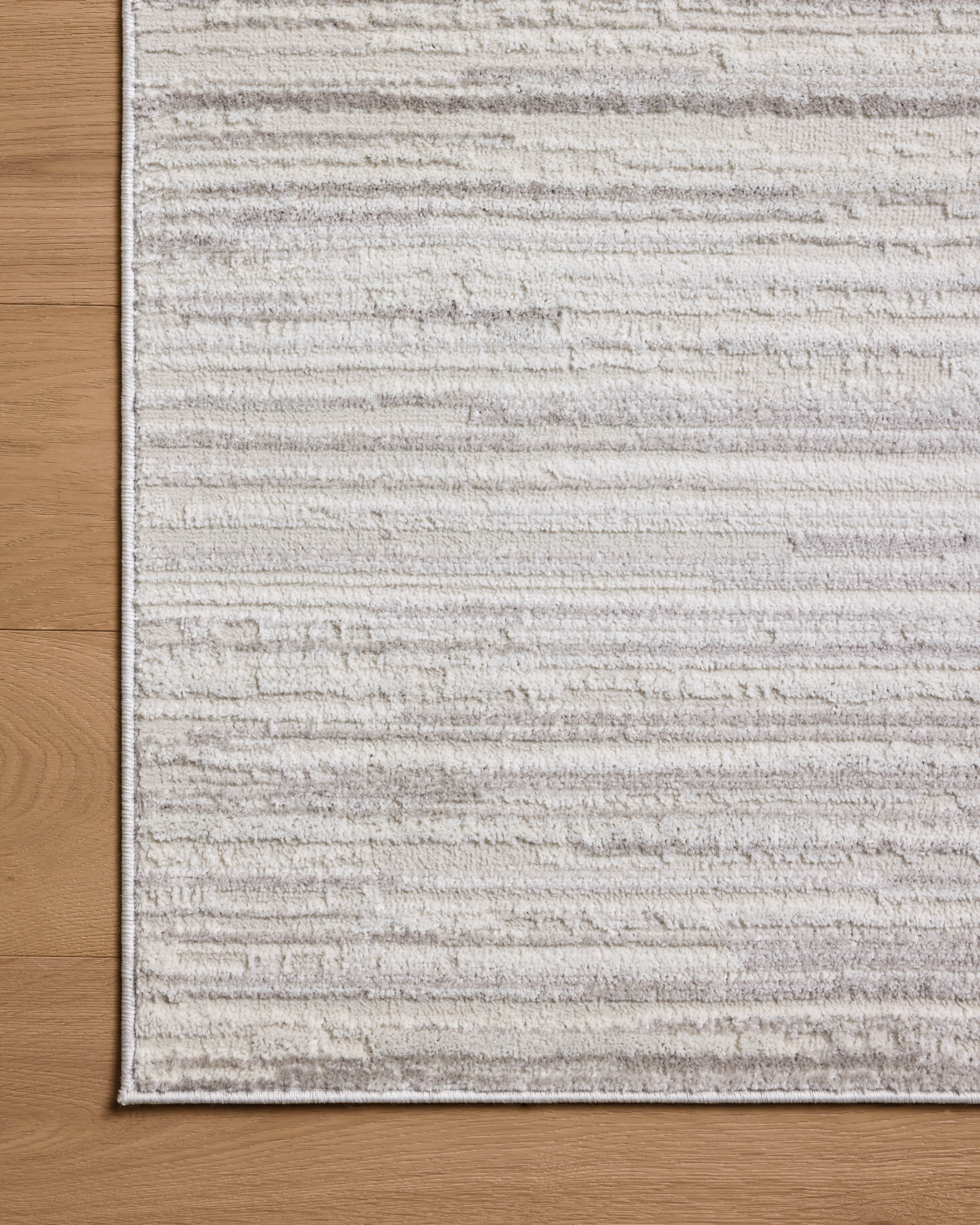 A power-loomed polyester area rug featuring abstract design and warm beige and elegant grey tones, the Townes TOW-05 Beige / Grey Area Rug adds character to any room