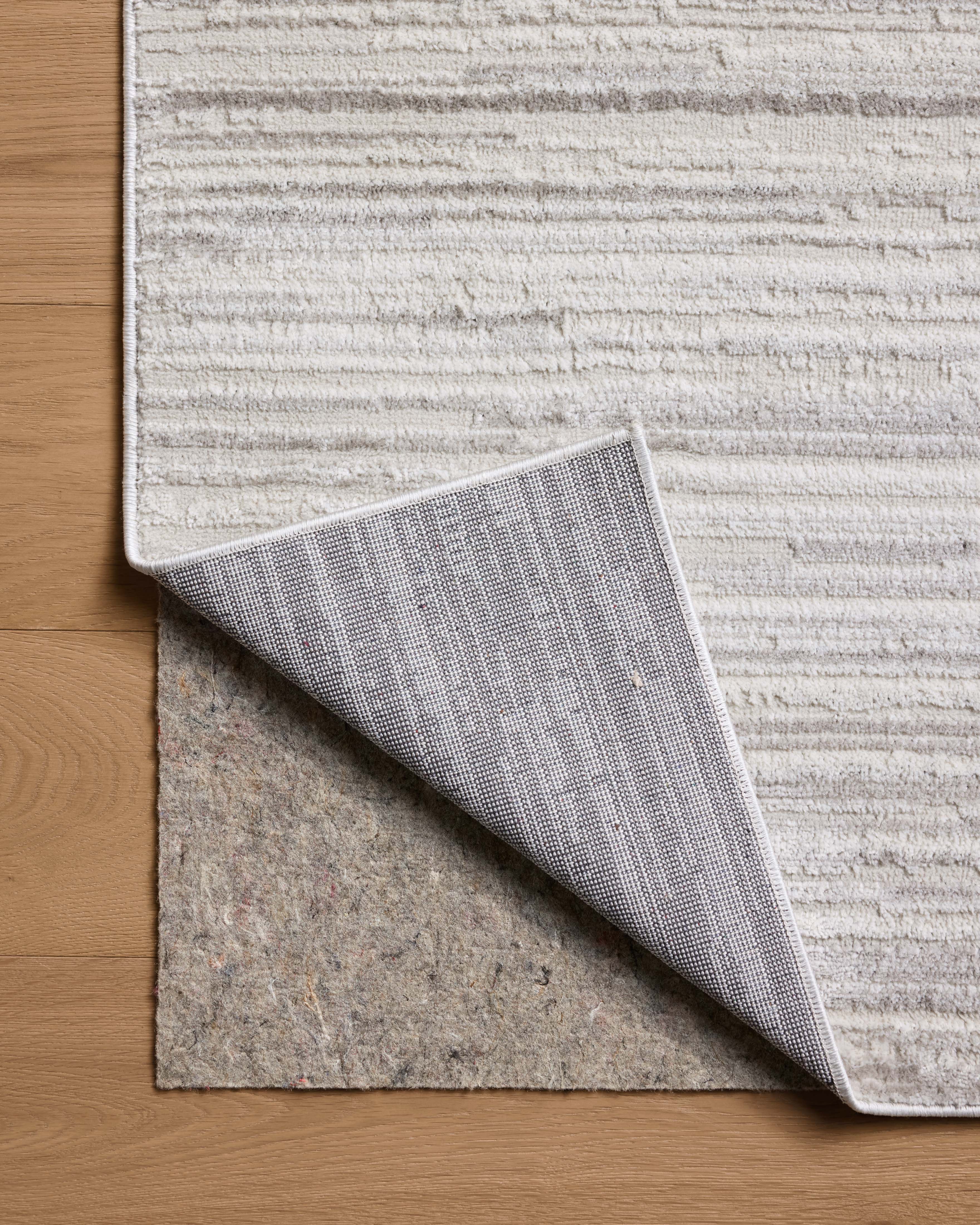 A power-loomed polyester area rug featuring abstract design and warm beige and elegant grey tones, the Townes TOW-05 Beige / Grey Area Rug adds character to any room