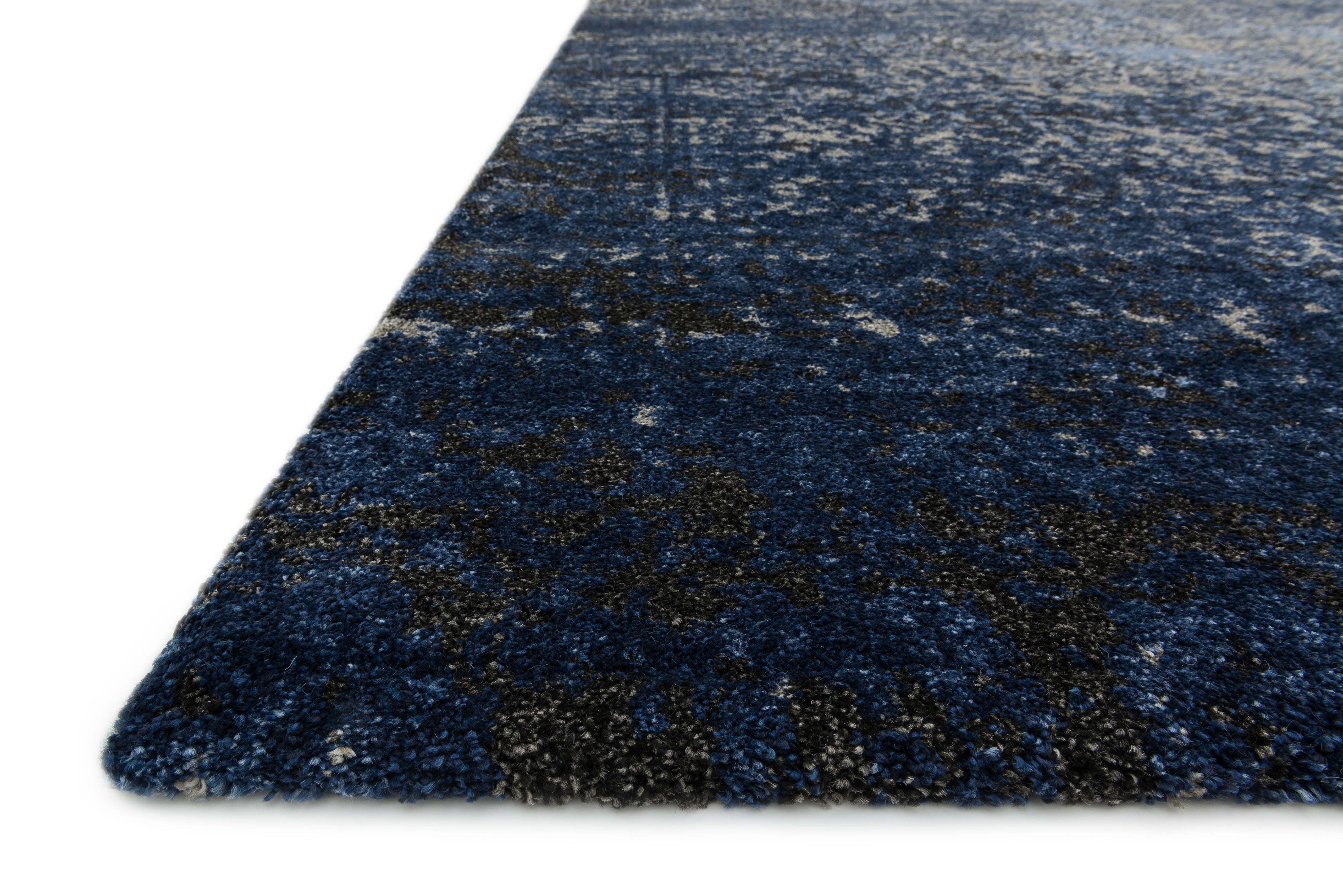 A power-loomed polypropylene and polyester area rug in elegant grey and classic navy tones with contemporary and vintage motifs, the Viera VR-07 Grey / Navy Area Rug grounds your room beautifully