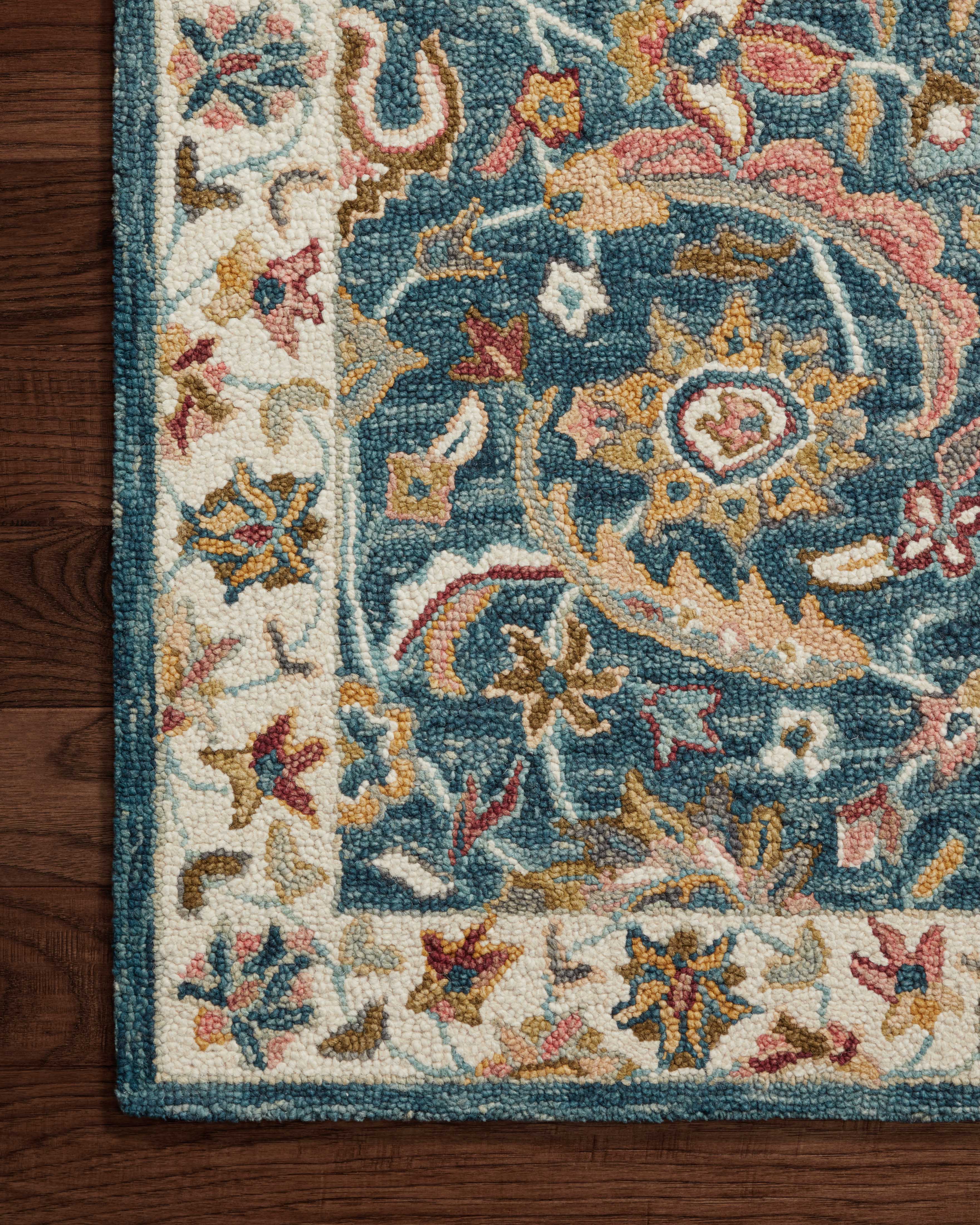 The Victoria VK-24 Ocean / Multi Area Rug showcases serene ocean and vibrant multi-toned tones in a hooked 100% wool area rug with traditional style
