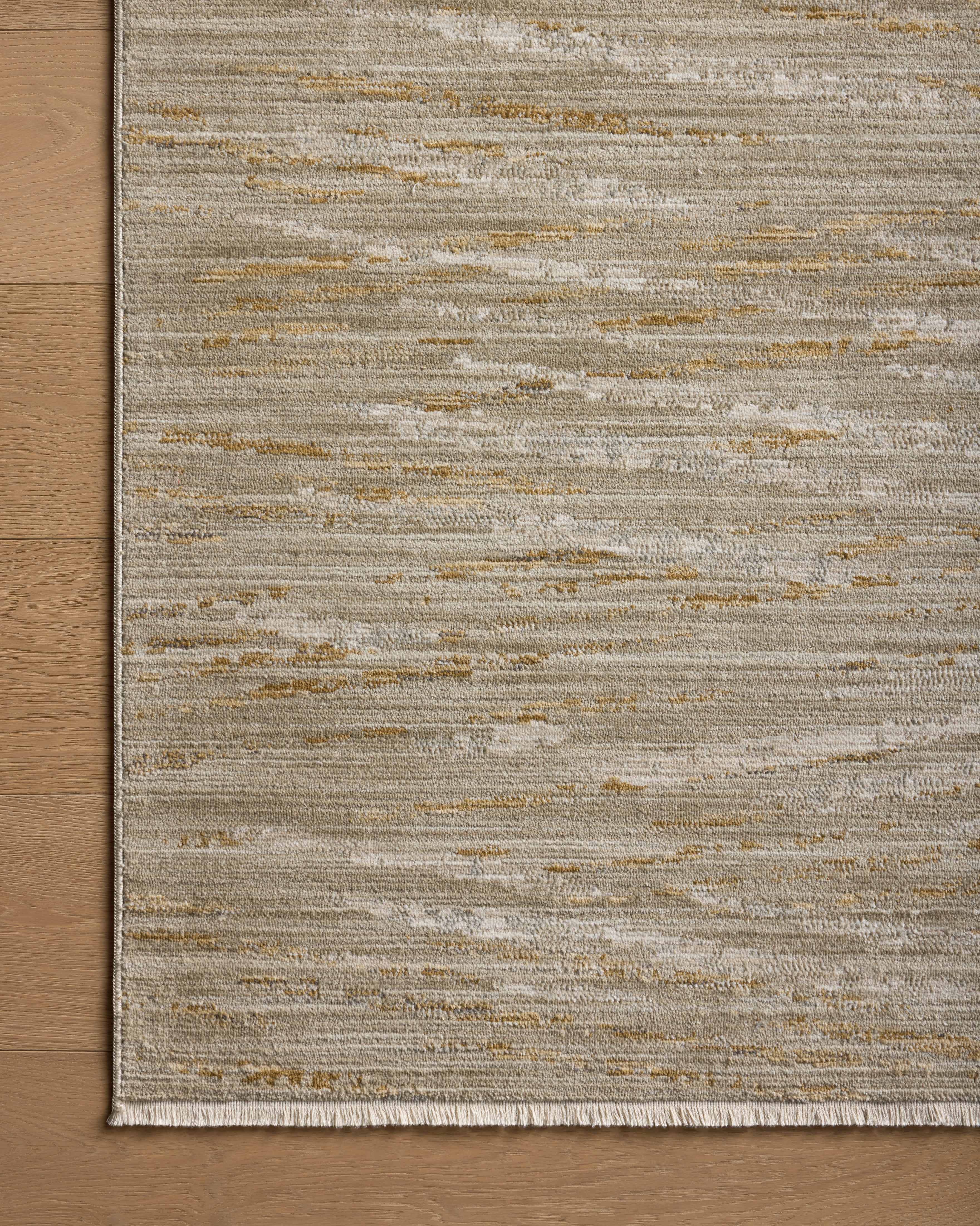 Featuring calming sage and radiant gold hues and abstract and linear detail, the Wade WAE-01 Sage / Gold Area Rug is a power-loomed 100% polyester area rug for any room