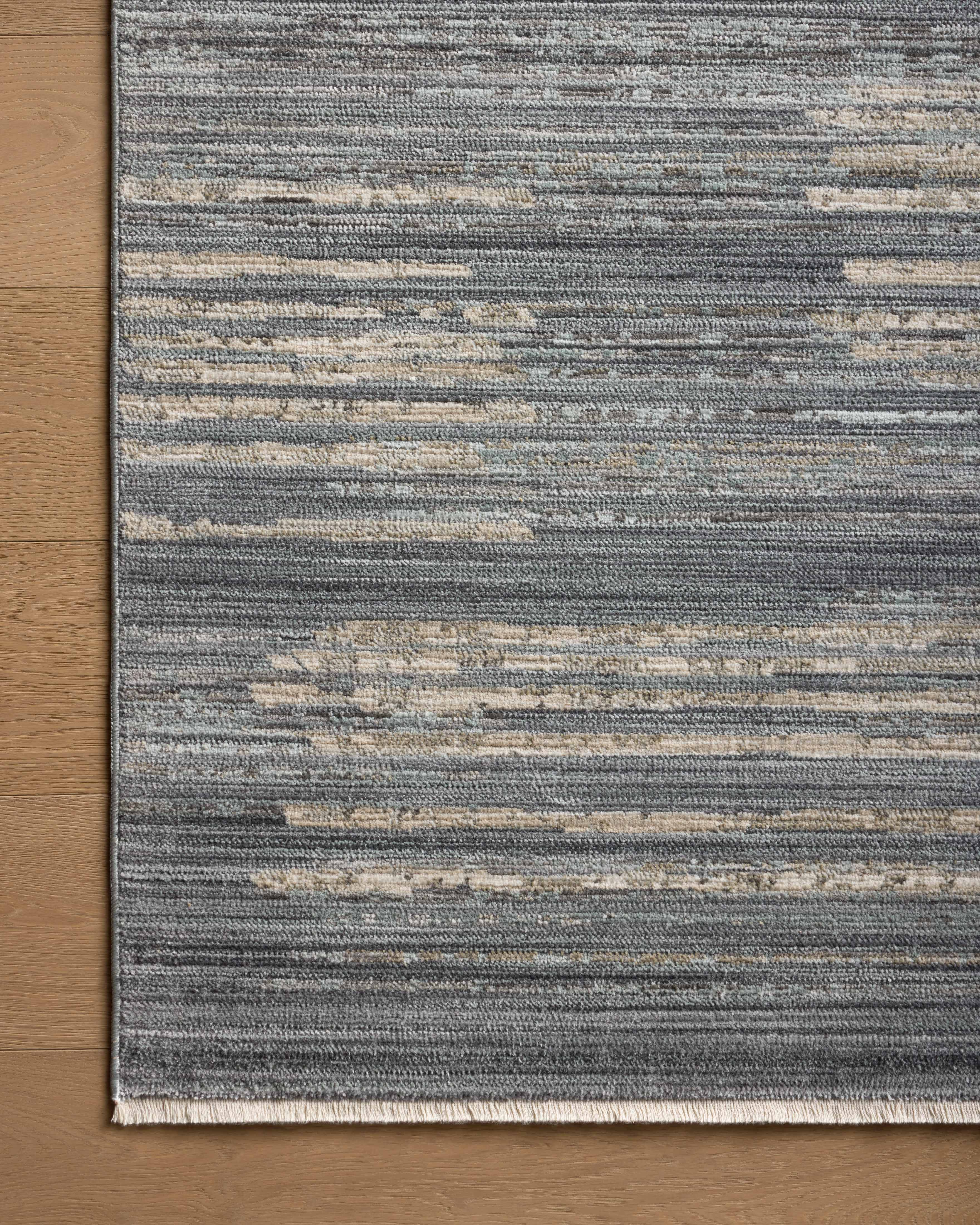 A power-loomed 100% polyester area rug with abstract and linear flair in serene ocean and sandy tones, the Wade WAE-02 Ocean / Sand Area Rug anchors any room