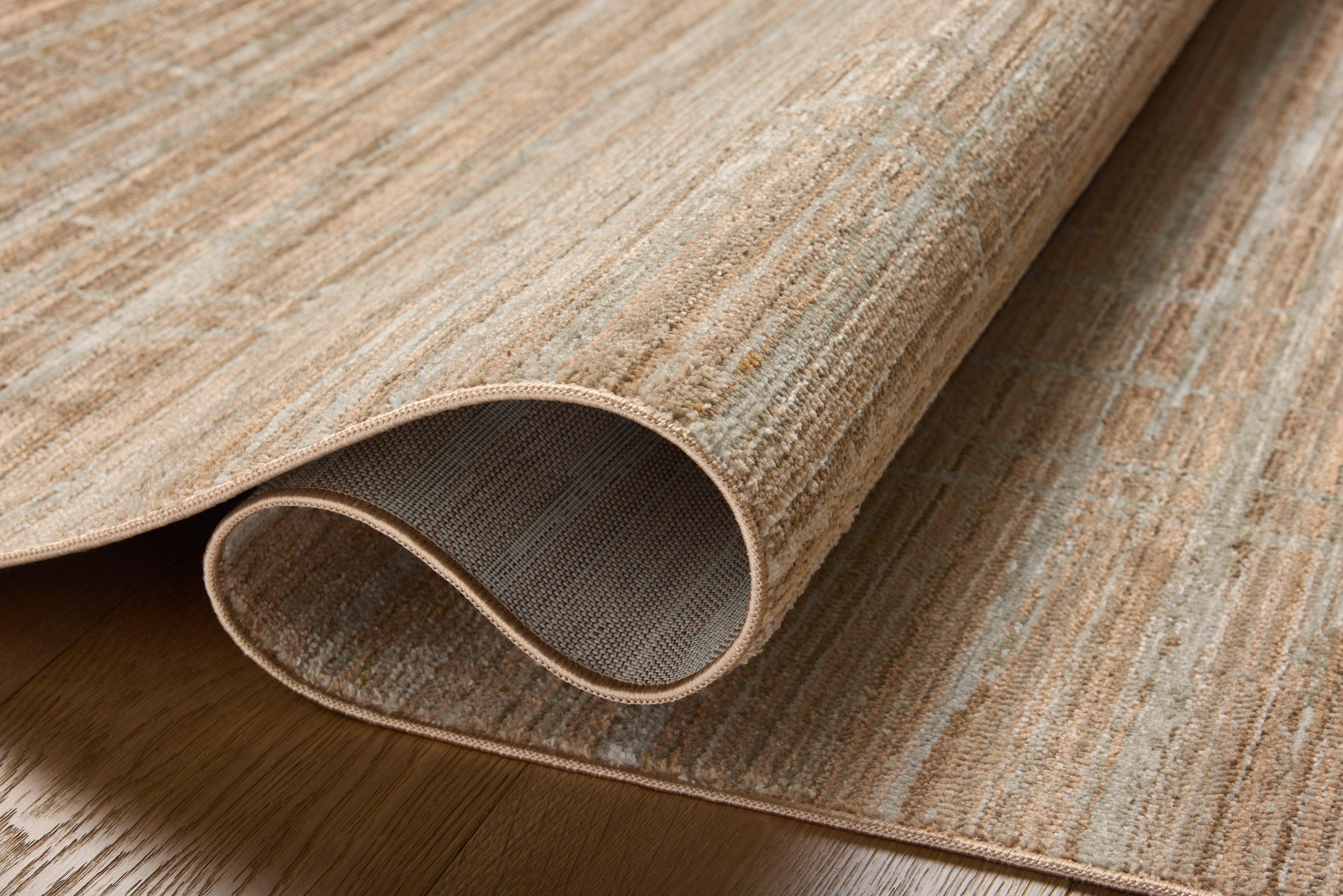 The Wade WAE-03 Clay / Silver Area Rug pairs earthy clay and shimmering silver tones and abstract and linear patterns in a power-loomed 100% polyester area rug