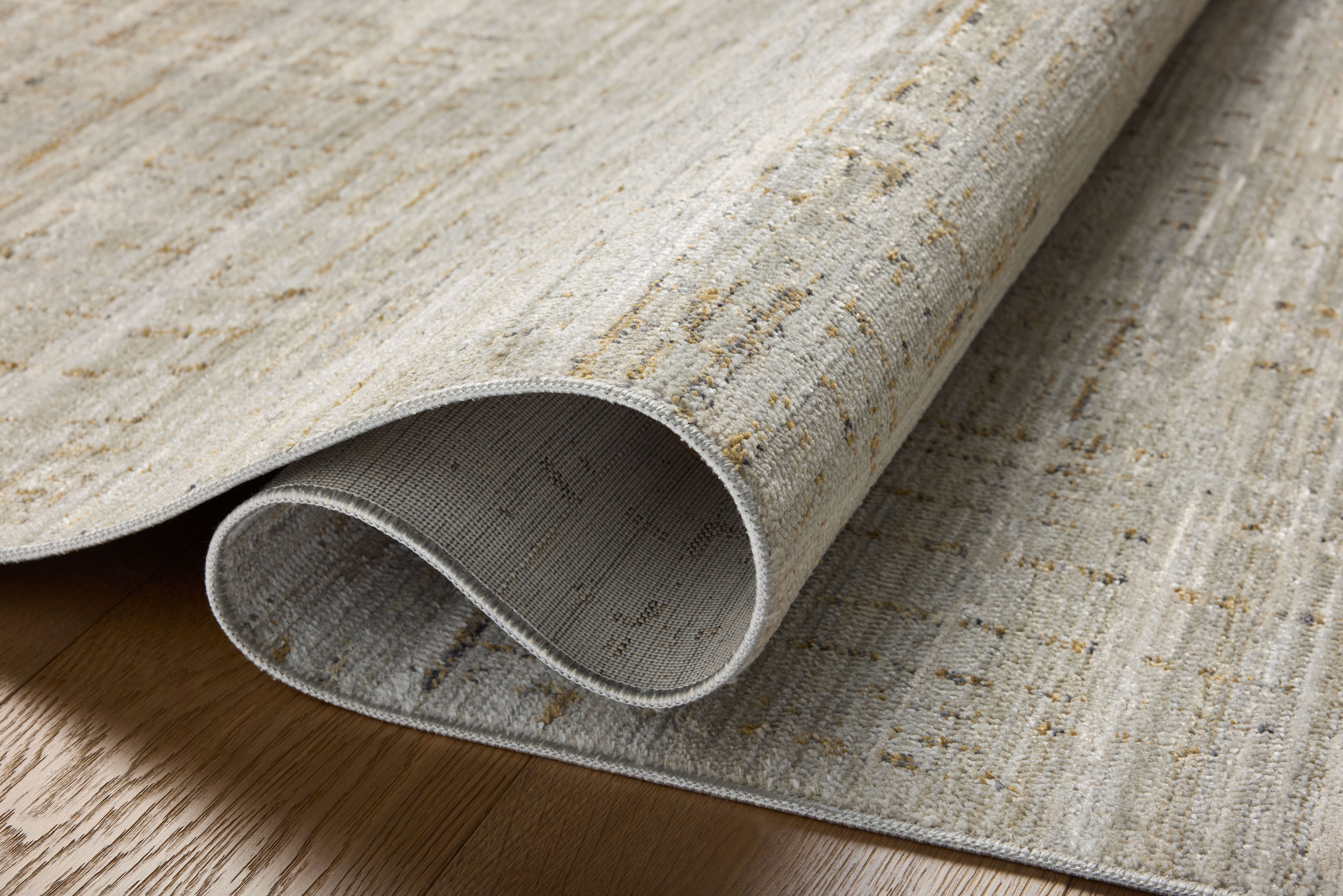 Crafted as a power-loomed 100% polyester area rug, the Wade WAE-03 Mist / Gold Area Rug brings soft misty and radiant gold warmth and abstract and linear character to your space