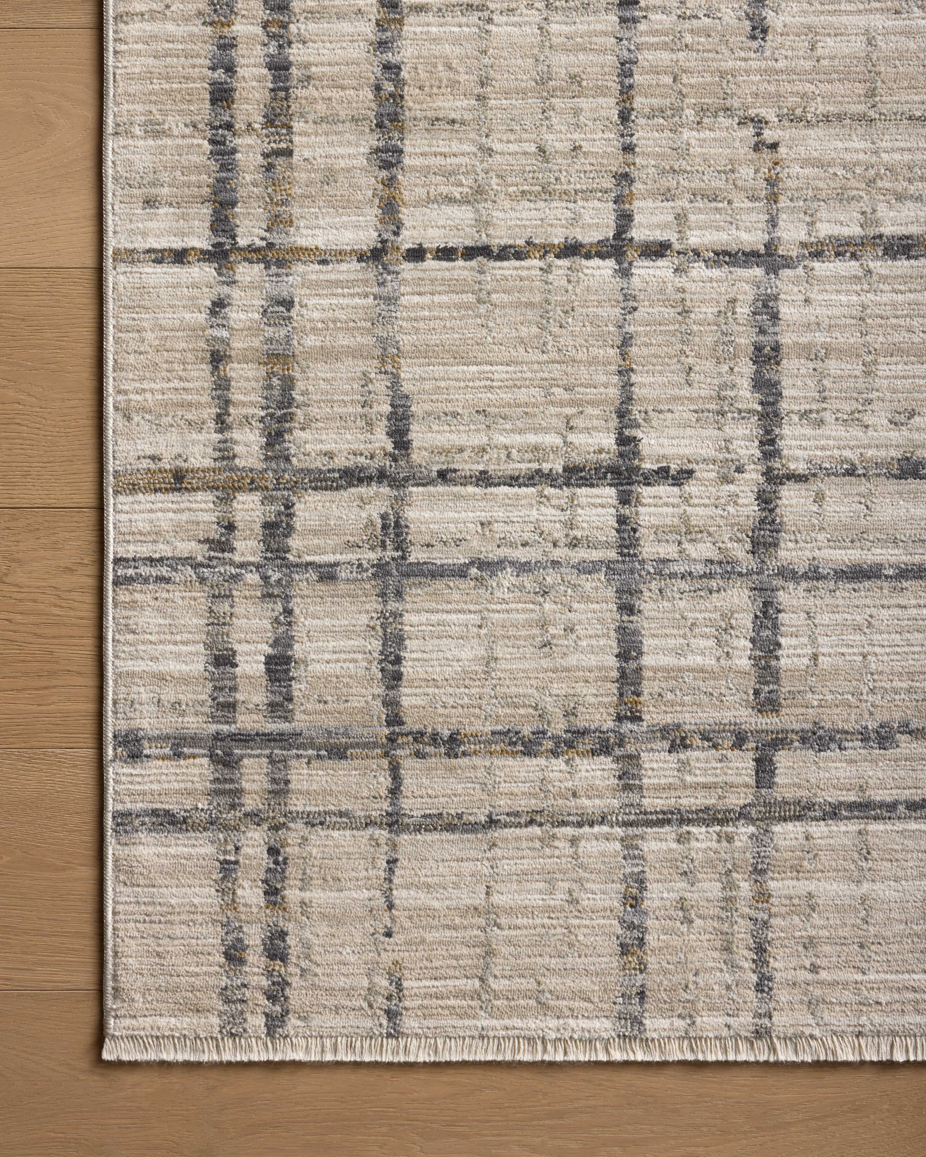 The Wade WAE-05 Beige / Midnight Area Rug delivers warm beige and dramatic midnight beauty and abstract and linear elegance in a power-loomed 100% polyester area rug