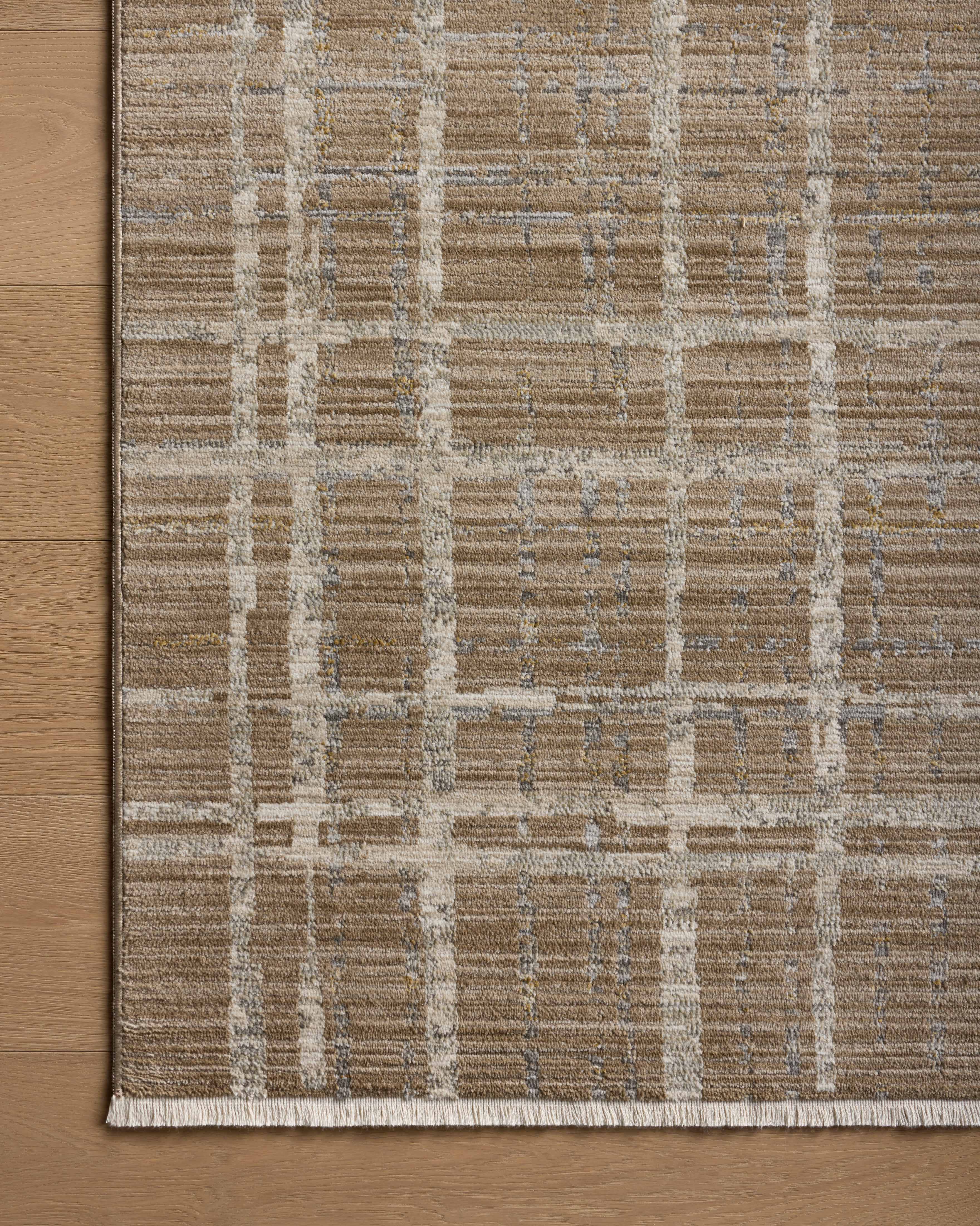 Designed with abstract and linear artistry in brown and grounding stone hues, the Wade WAE-05 Brown / Stone Area Rug is a power-loomed 100% polyester area rug that stands out