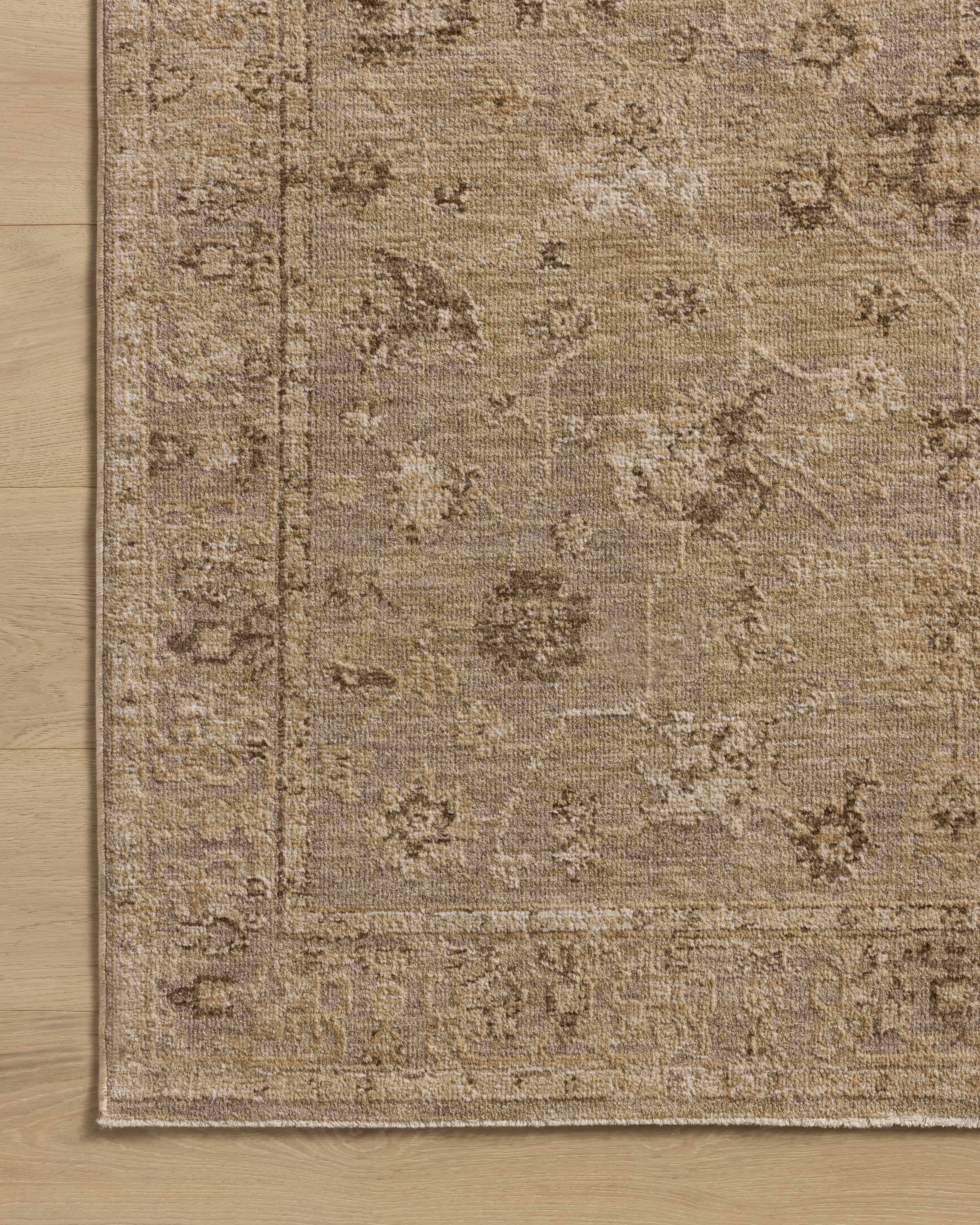 A power-loomed 100% polyester area rug featuring traditional and vintage design and versatile taupe and warm natural tones, the Willa WIA-02 Taupe / Natural Area Rug adds character to any room