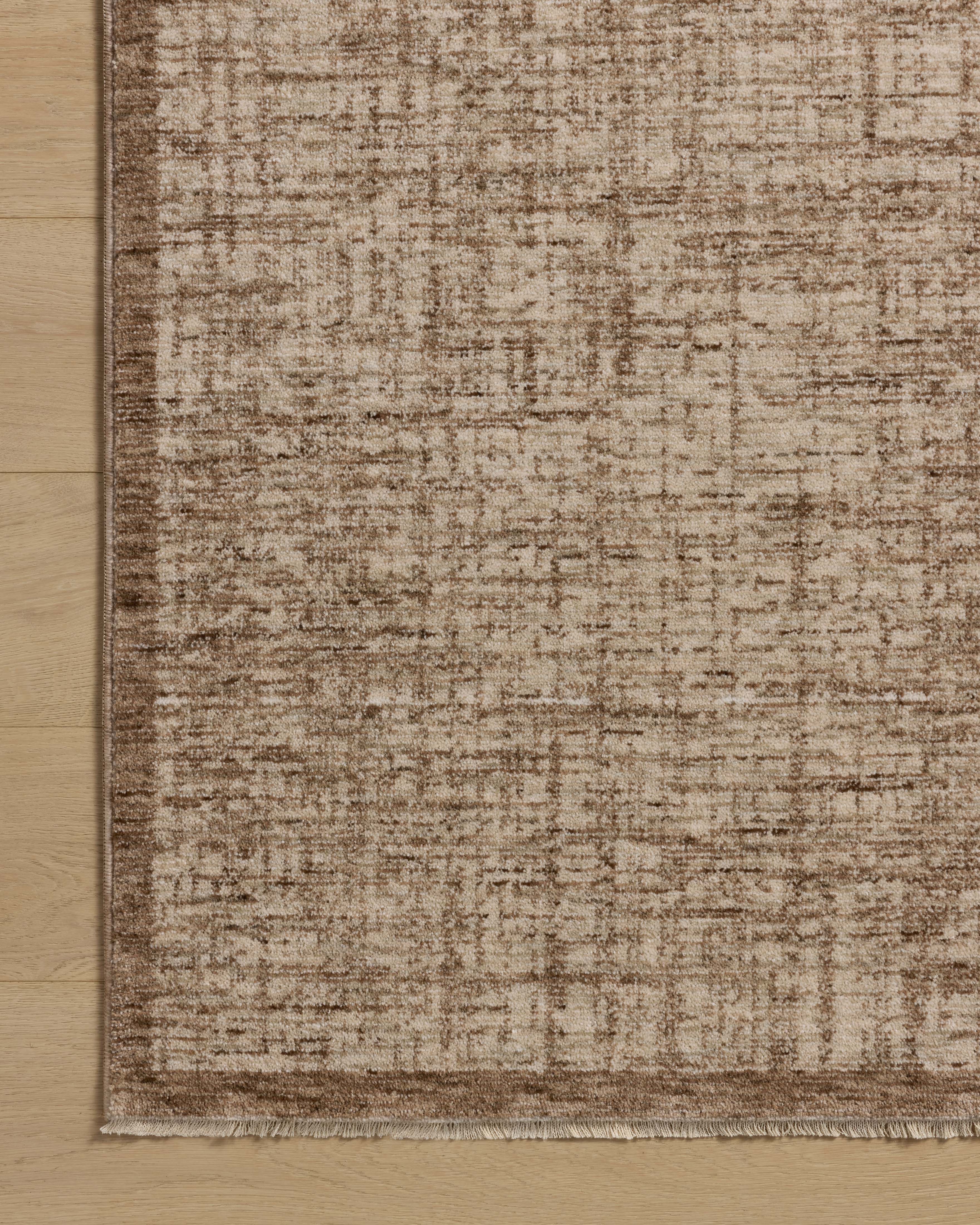 The Winston WIT-01 Earth / Bone Area Rug is a power-loomed polyester area rug that radiates earthy and bone charm