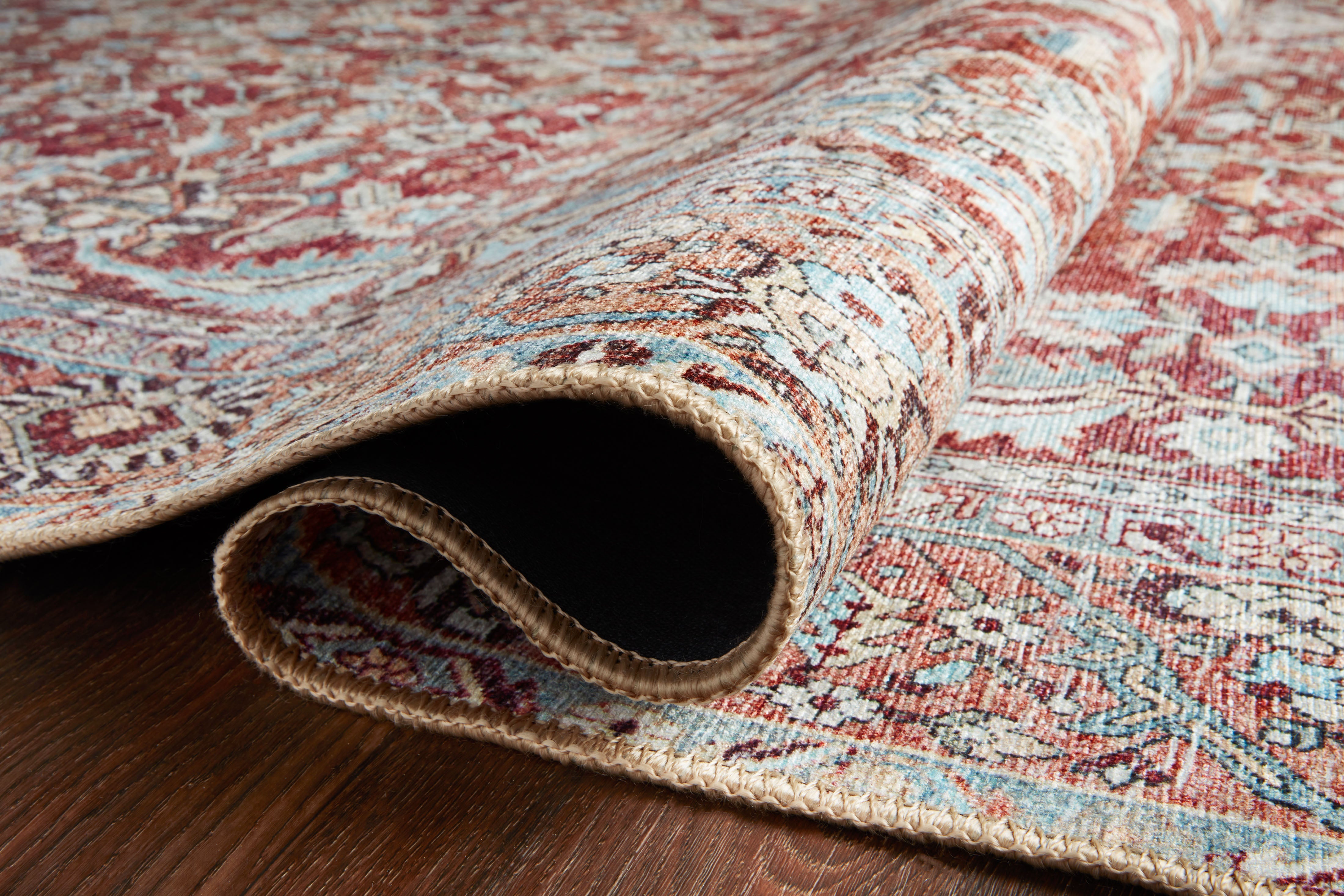 A power-loomed 100% polyester area rug in tomato and vibrant teal tones, the Wynter WYN-05 Tomato / Teal Area Rug grounds your room beautifully