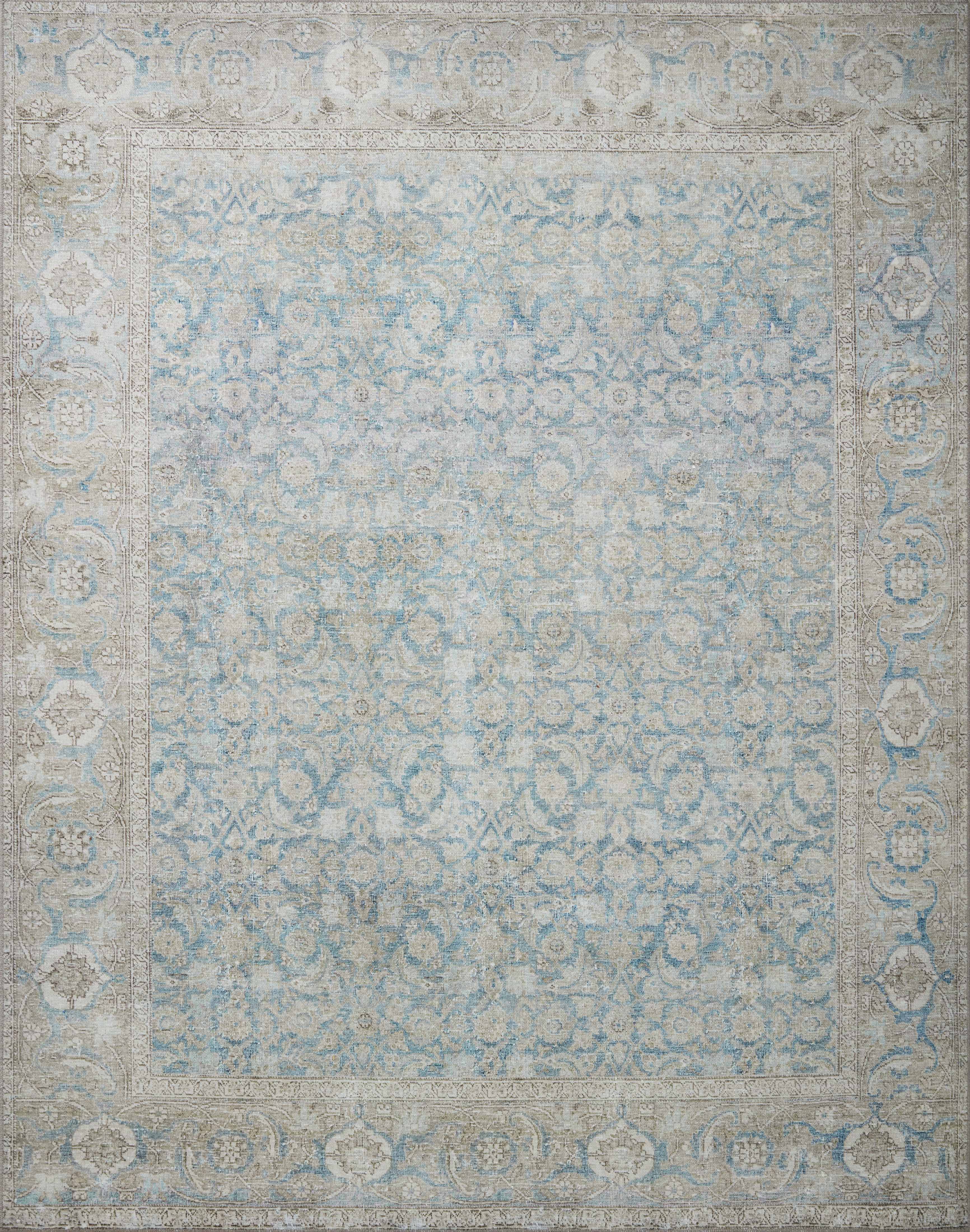 A power-loomed 100% polyester area rug in serene ocean and shimmering silver tones, the Wynter WYN-10 Ocean / Silver Area Rug anchors any room