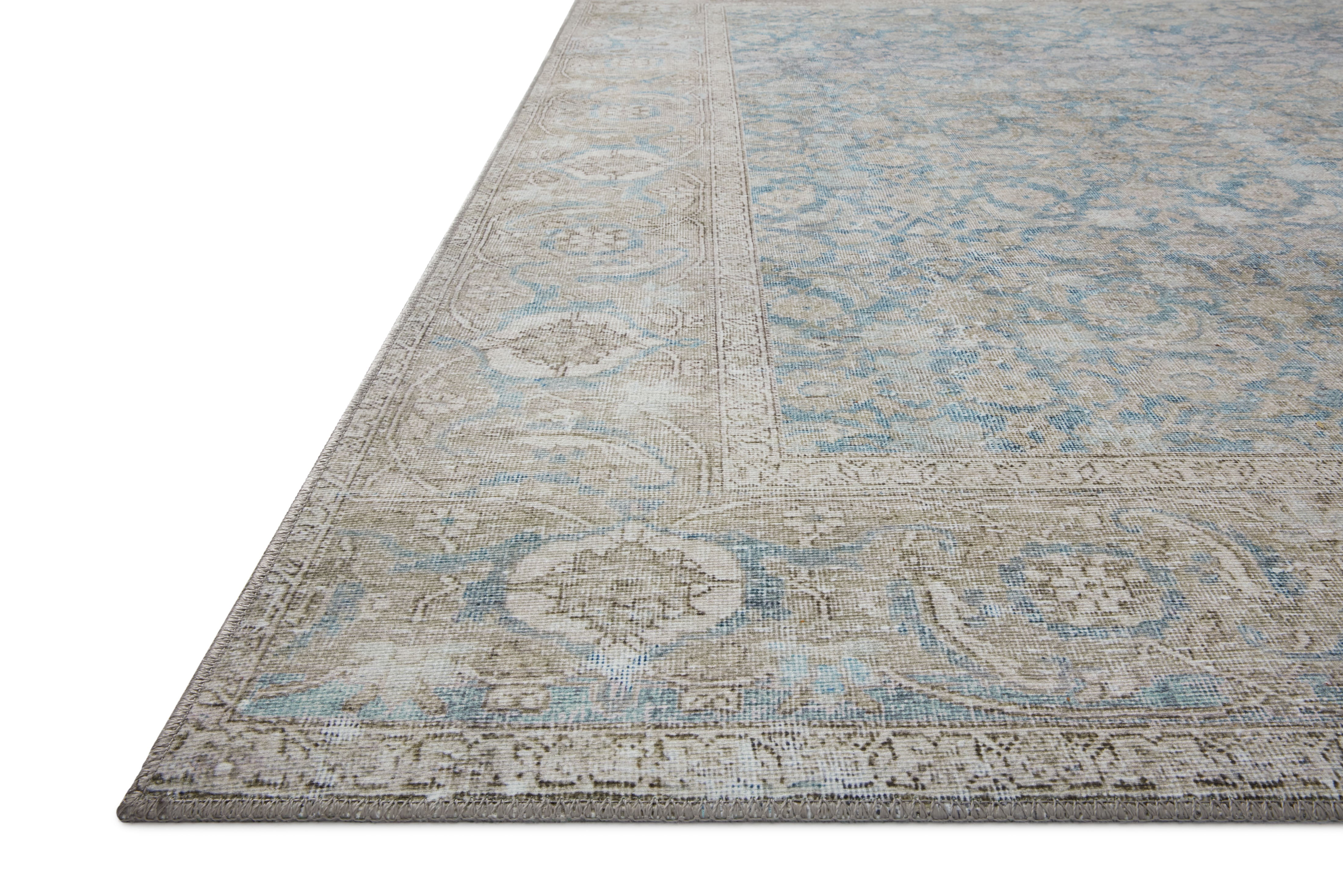 A power-loomed 100% polyester area rug in serene ocean and shimmering silver tones, the Wynter WYN-10 Ocean / Silver Area Rug anchors any room