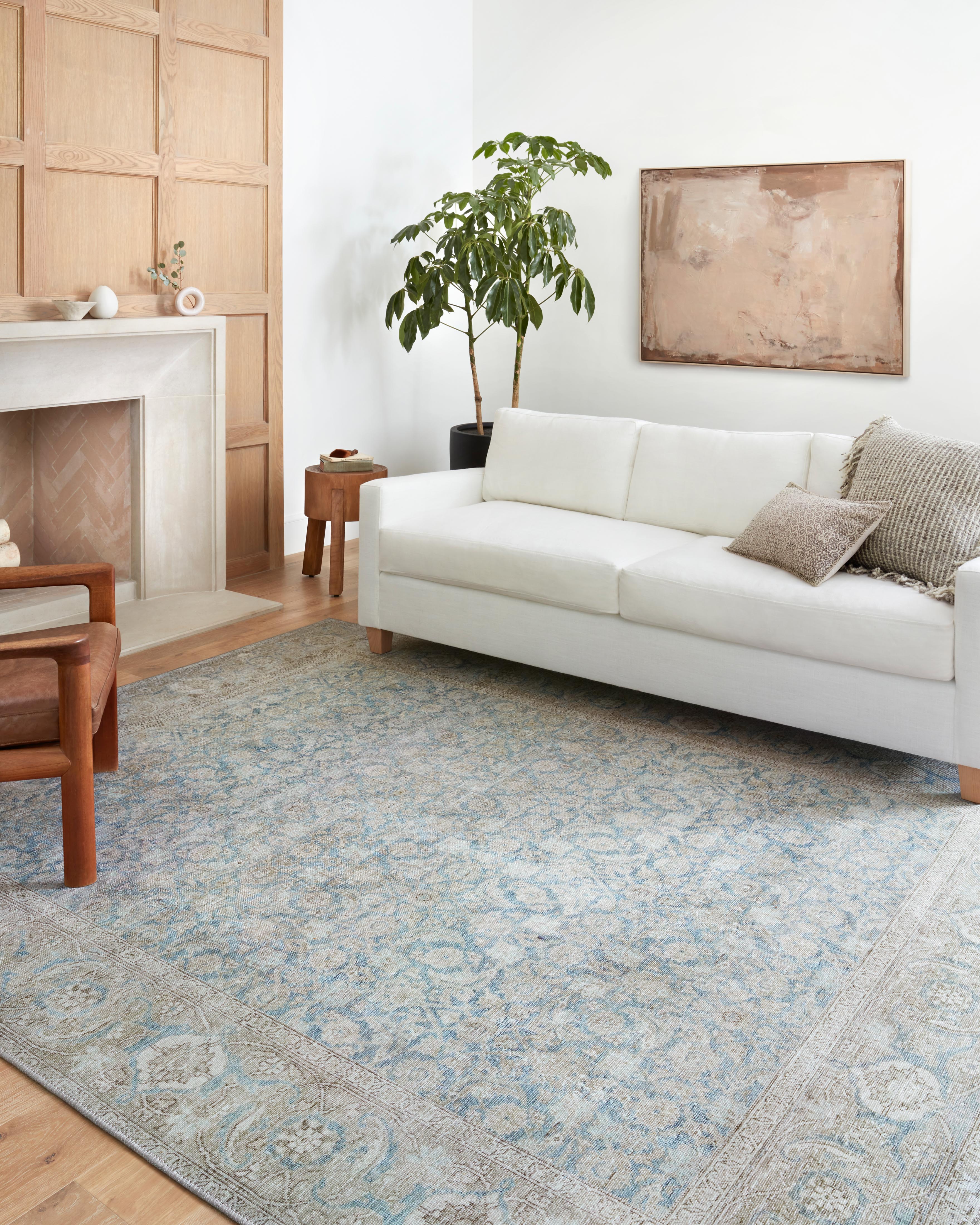 A power-loomed 100% polyester area rug in serene ocean and shimmering silver tones, the Wynter WYN-10 Ocean / Silver Area Rug anchors any room