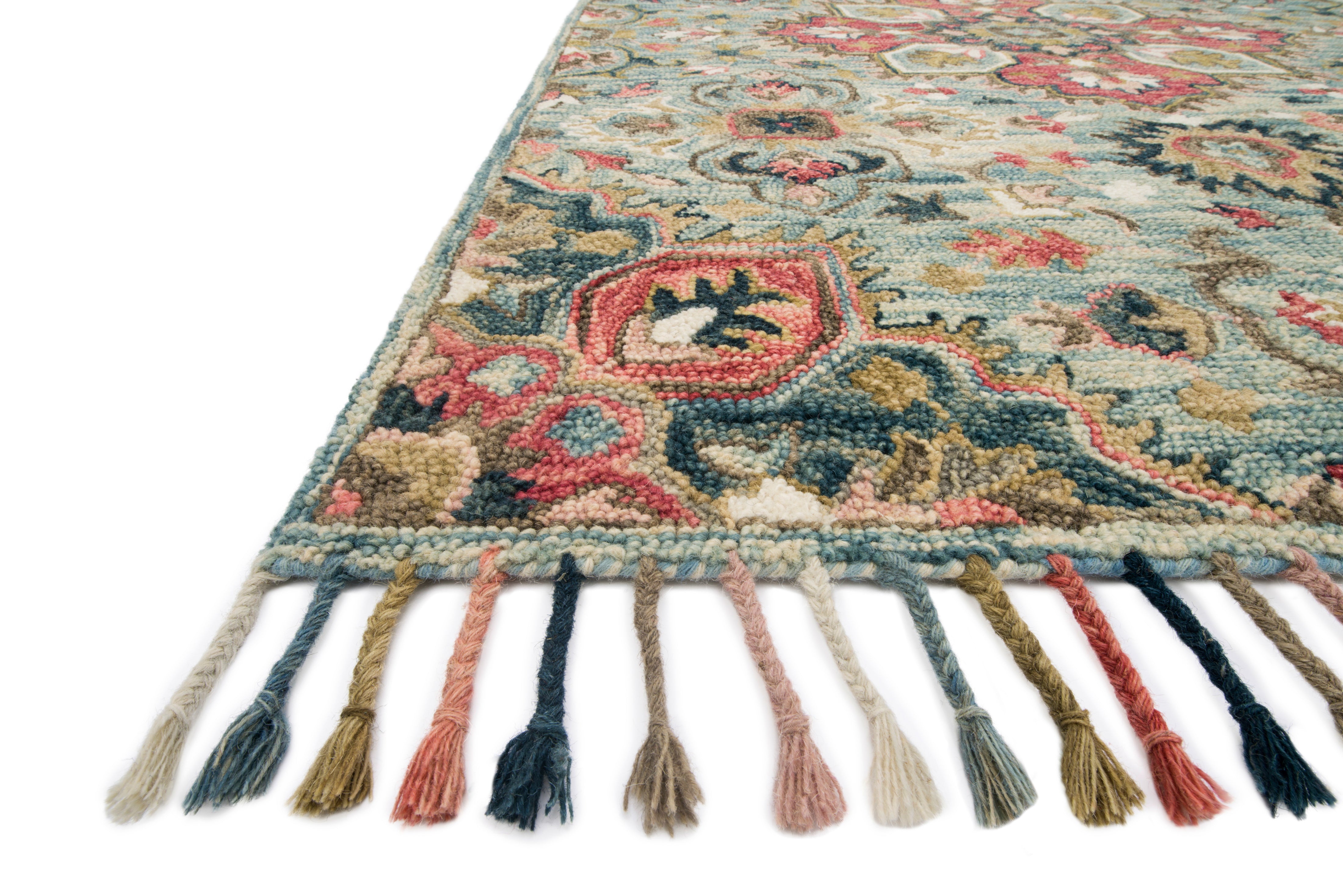 The Zharah ZR-13 Light Blue / Multi Area Rug brings light blue and vibrant multi-toned character to your home in a hooked 100% wool area rug