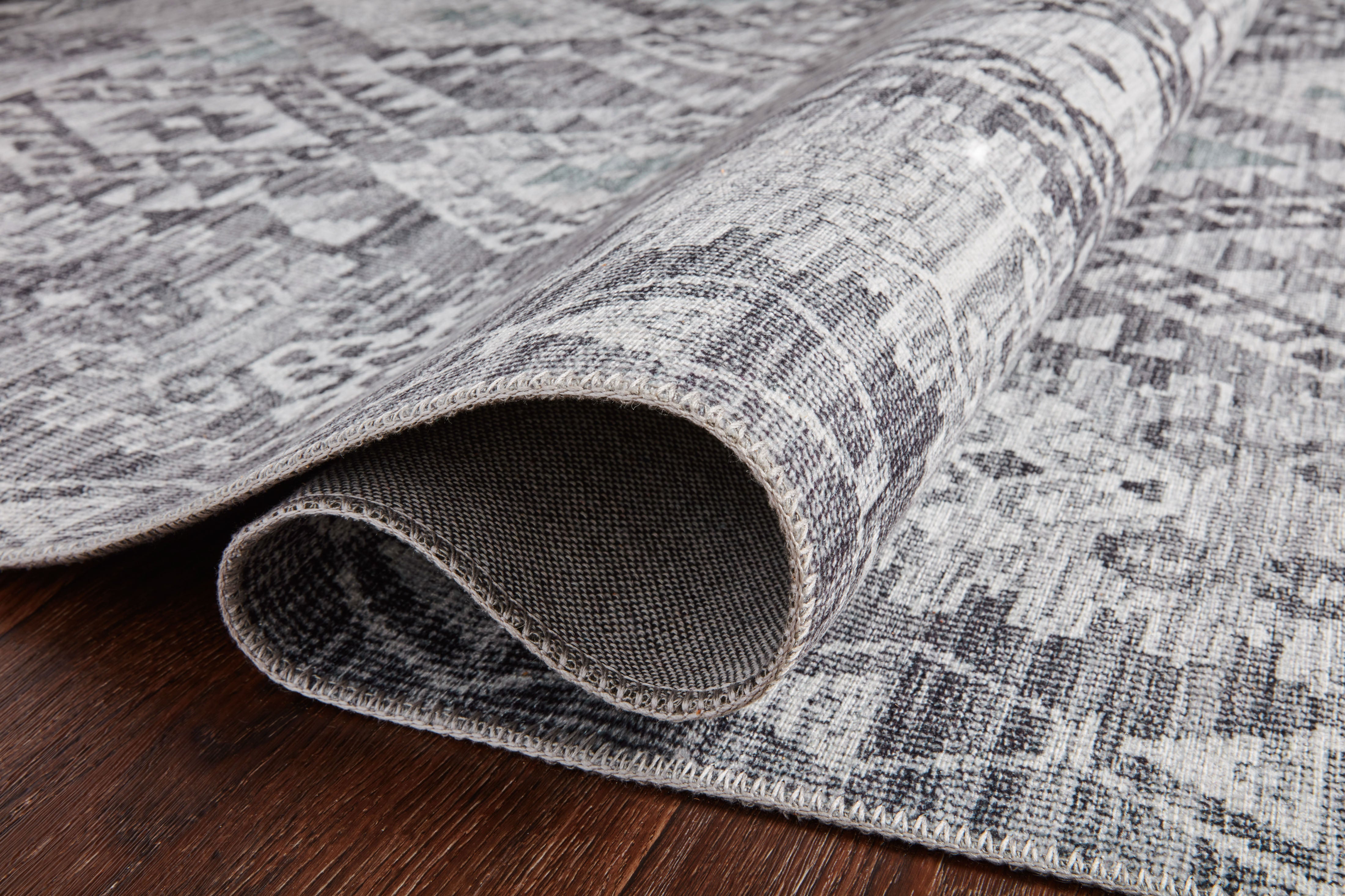 The Zion ZIO-03 Charcoal / Slate Area Rug highlights deep charcoal and cool slate tones in a beautifully made power-loomed 100% polyester area rug