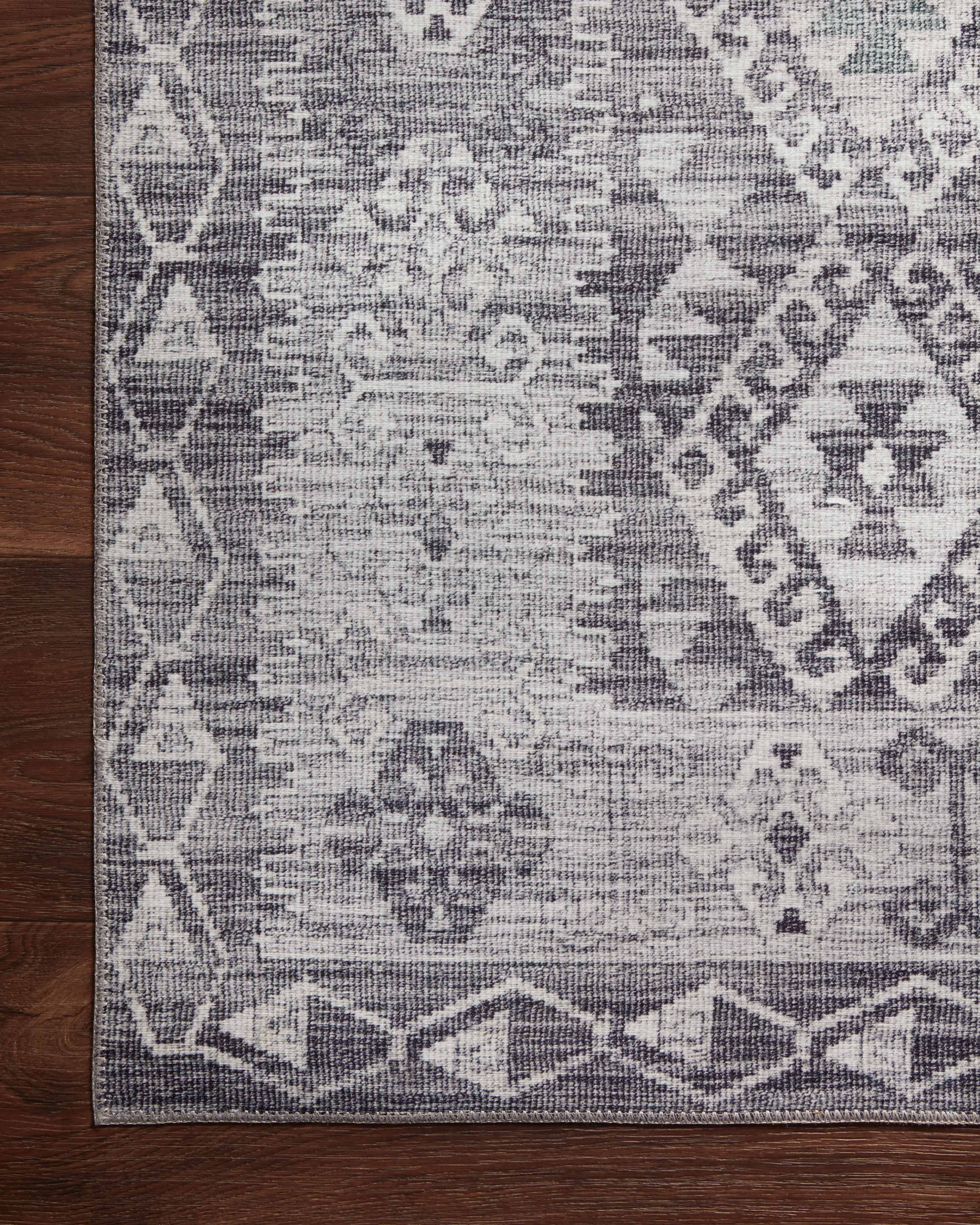 The Zion ZIO-03 Charcoal / Slate Area Rug highlights deep charcoal and cool slate tones in a beautifully made power-loomed 100% polyester area rug