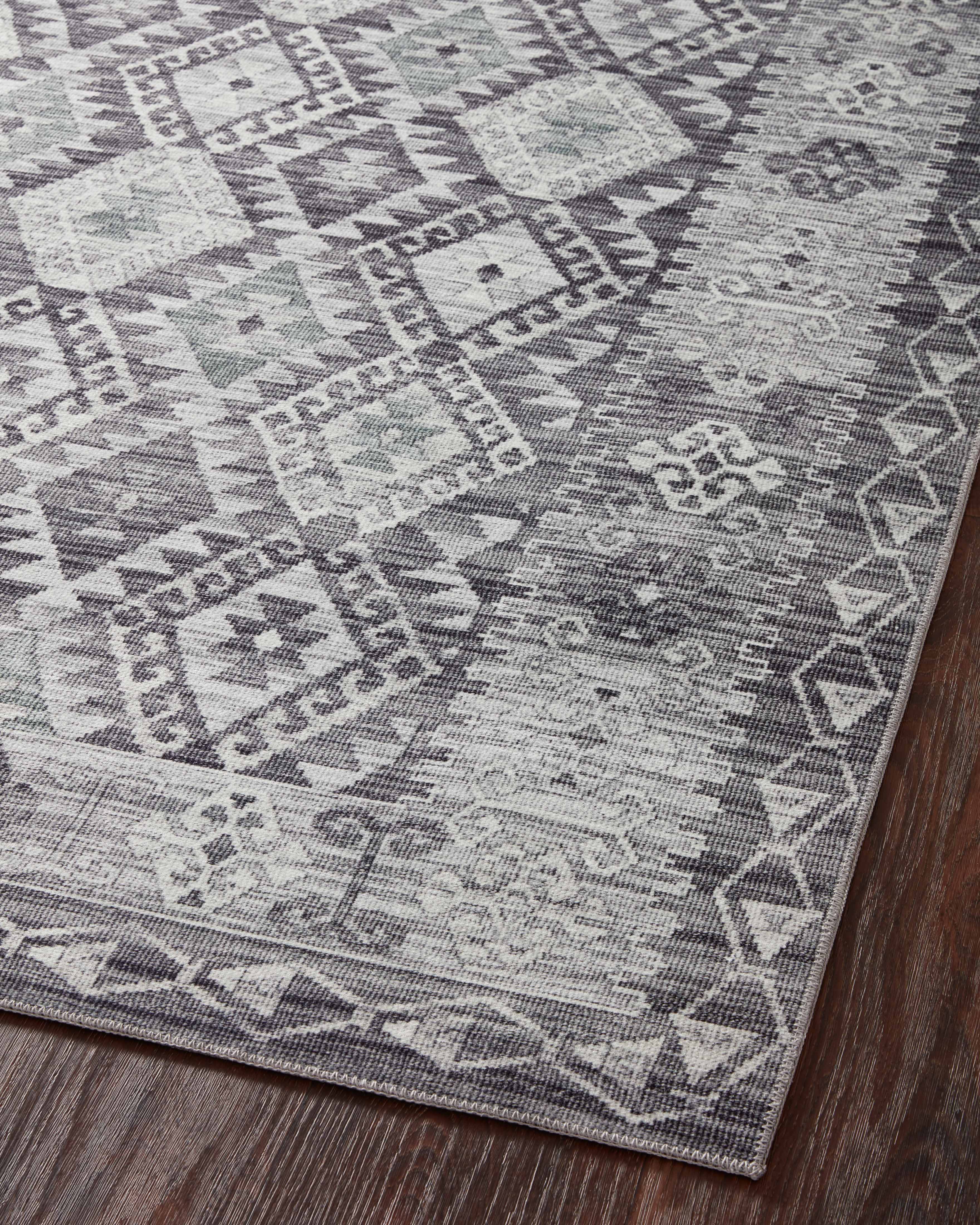 The Zion ZIO-03 Charcoal / Slate Area Rug highlights deep charcoal and cool slate tones in a beautifully made power-loomed 100% polyester area rug