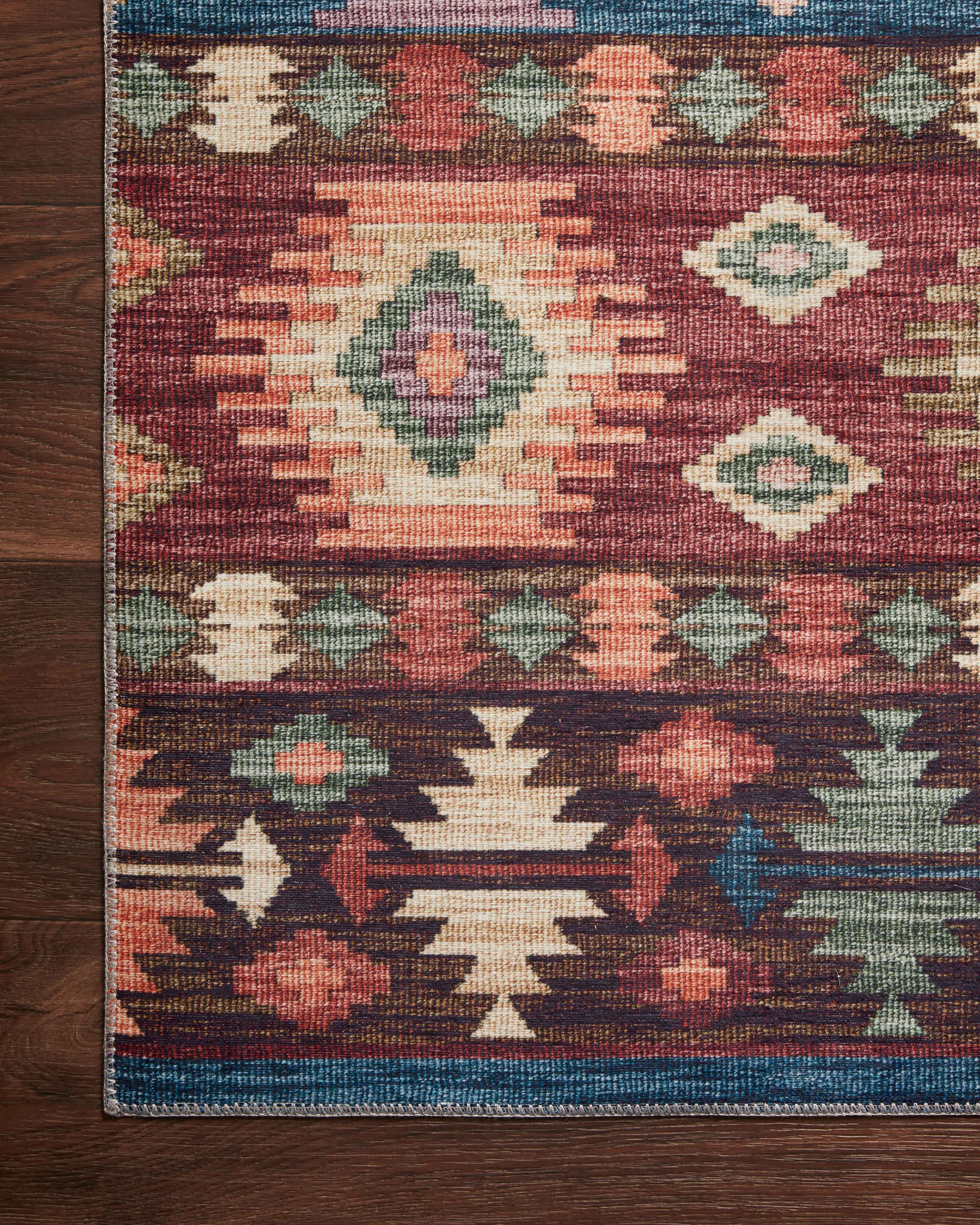 A power-loomed 100% polyester area rug in lively fiesta and vibrant multi-toned tones, the Zion ZIO-06 Fiesta / Multi Area Rug grounds your room beautifully