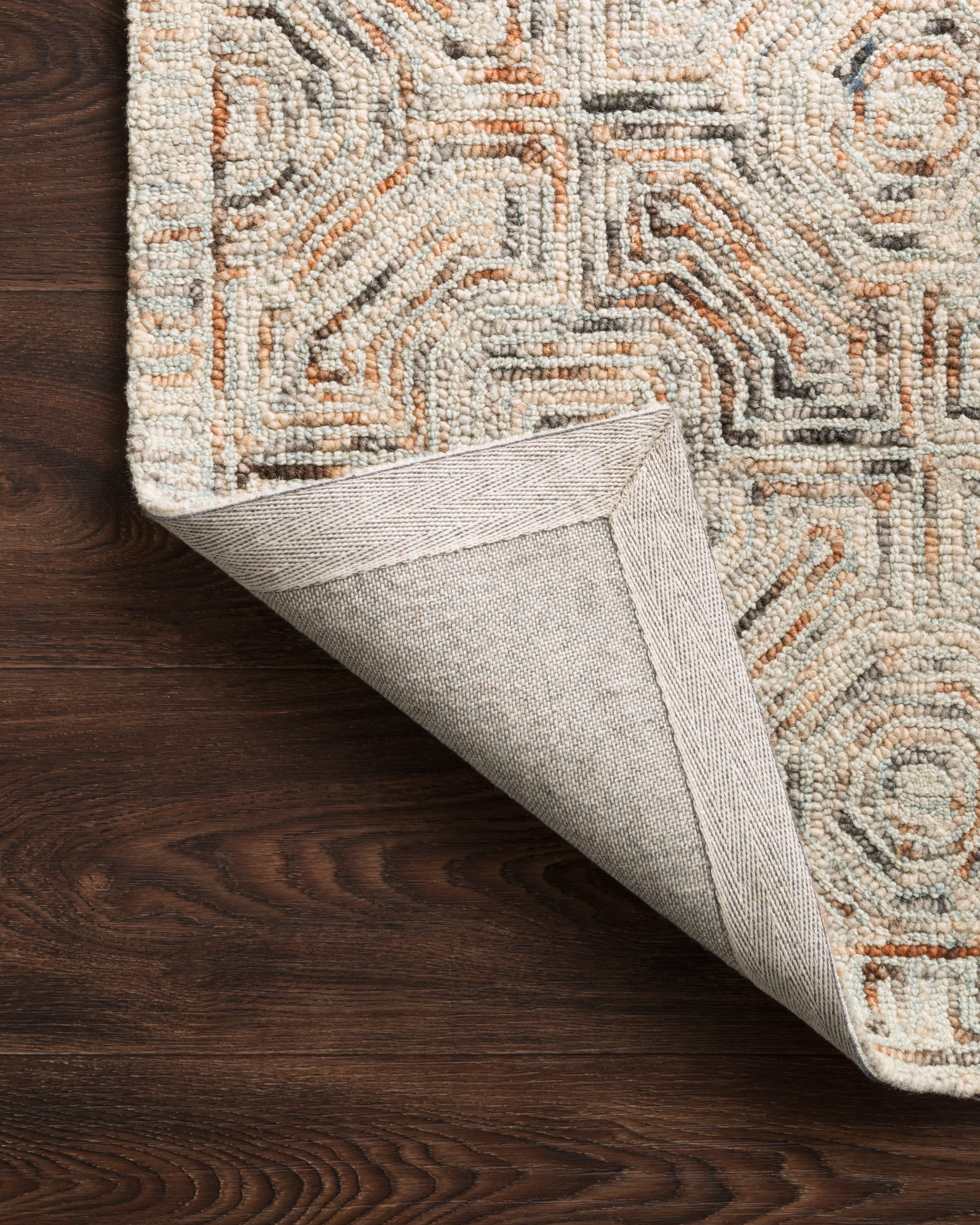 Layered in vibrant multi-toned hues with contemporary and linear patterns, the Ziva ZV-02 Multi Area Rug is a hand-tufted 100% wool area rug perfect for any setting
