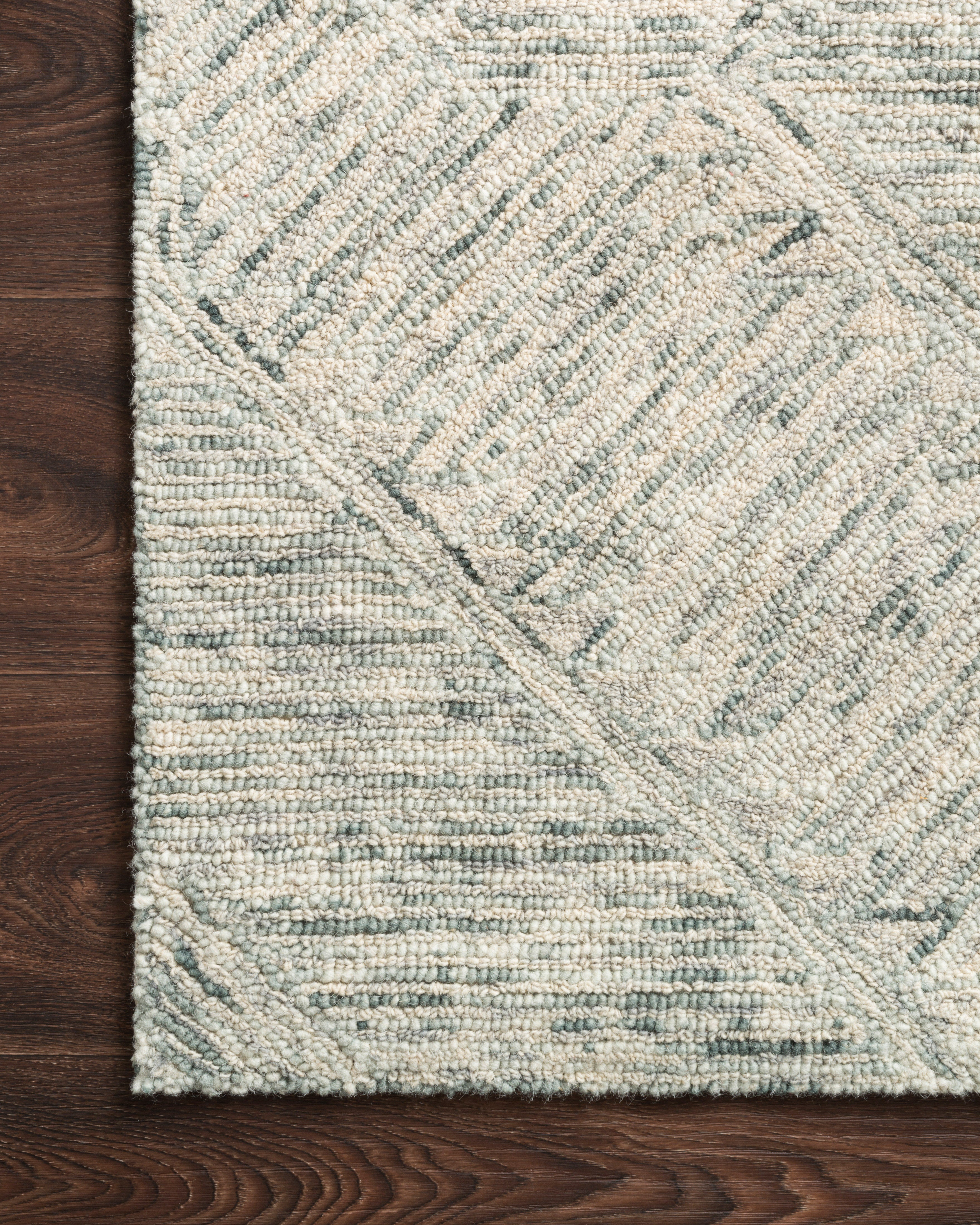 A hand-tufted 100% wool area rug with contemporary and linear flair in breezy sky-blue tones, the Ziva ZV-05 Sky Area Rug anchors any room