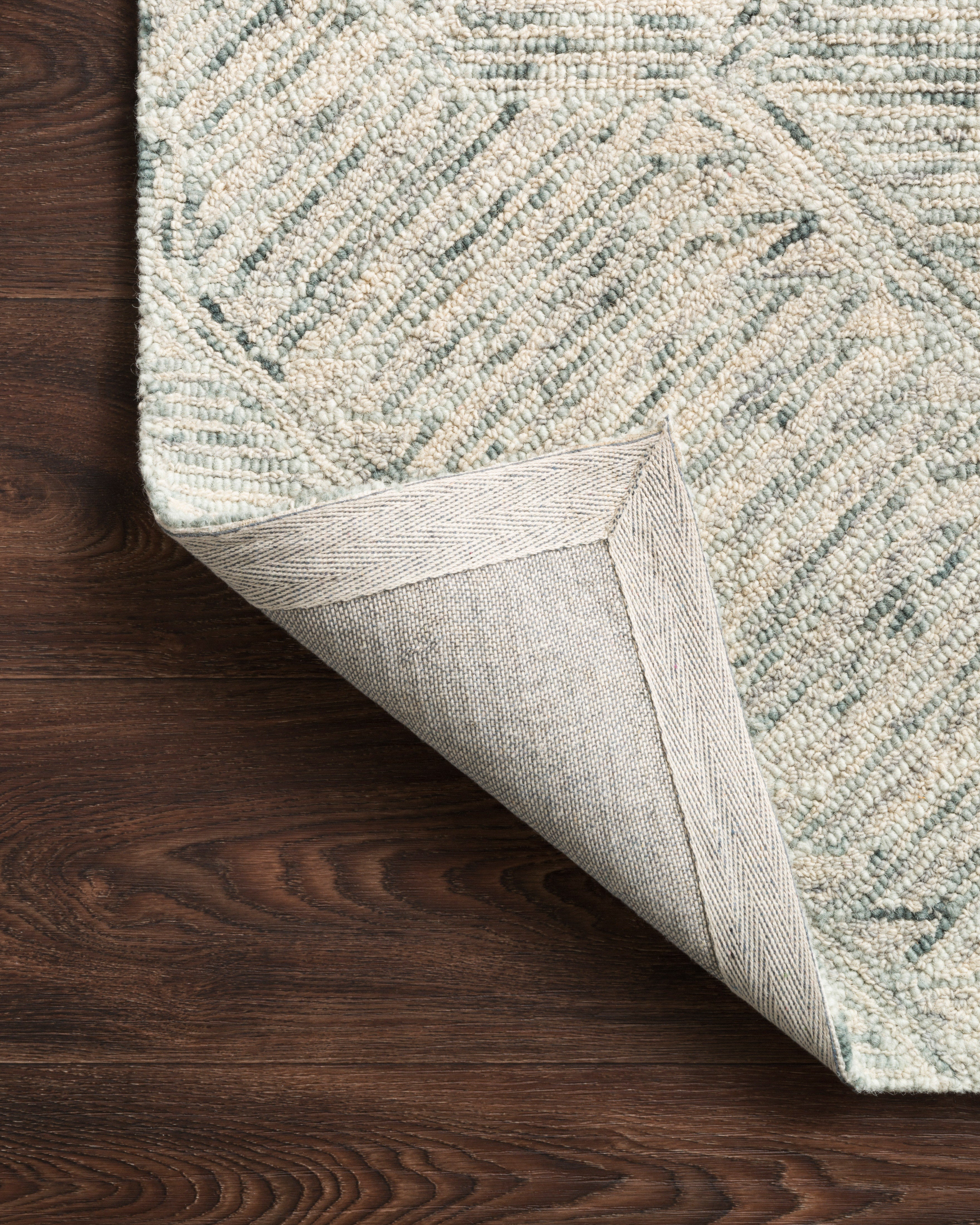 A hand-tufted 100% wool area rug with contemporary and linear flair in breezy sky-blue tones, the Ziva ZV-05 Sky Area Rug anchors any room
