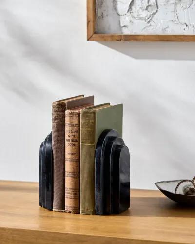 Livabliss Aayena EYA-001 Black marble bookends with curved geometric lines holding vintage hardcover books on a wooden shelf.
