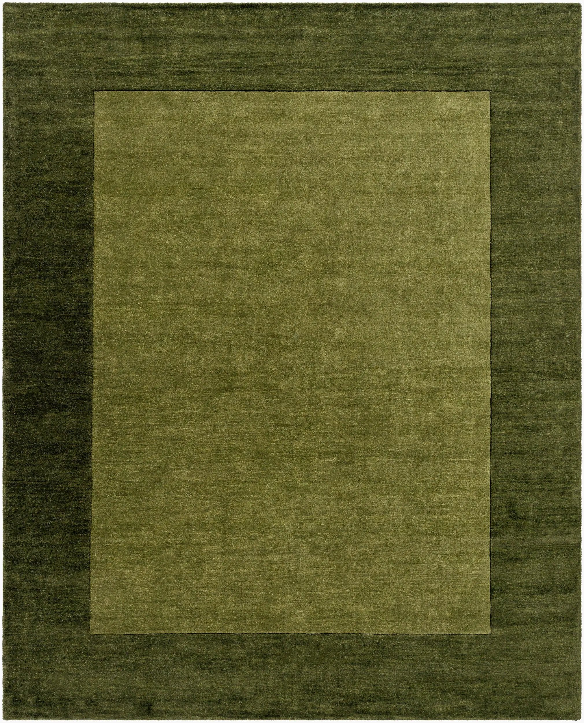 Livabliss Mystique M-315 Olive area rug with dark border and lighter center, featuring a textured wool pile and traditional hand-loomed design.