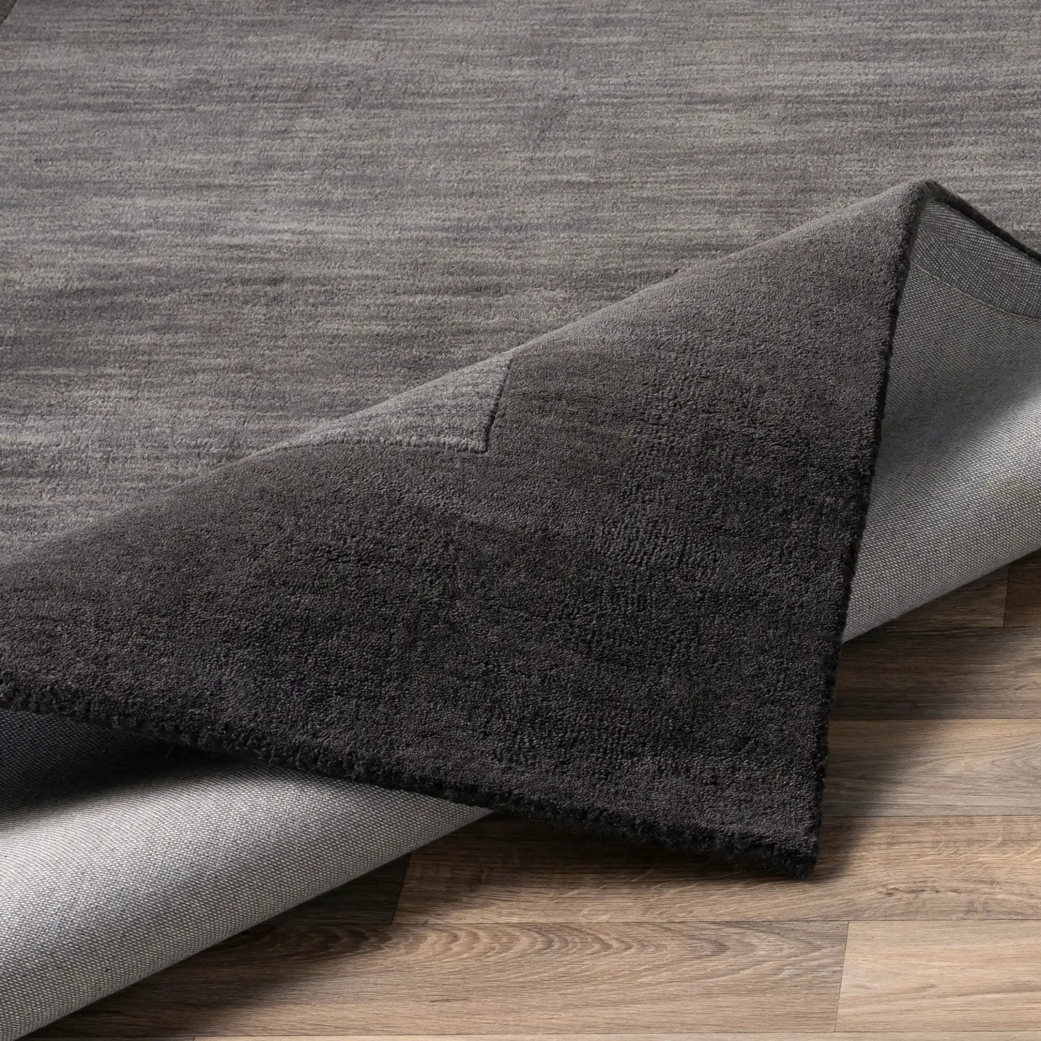 Livabliss Mystique M-347 Charcoal area rug featuring refined high-low pile texture and durable comfort, ideal for grounding modern living spaces and bedrooms.