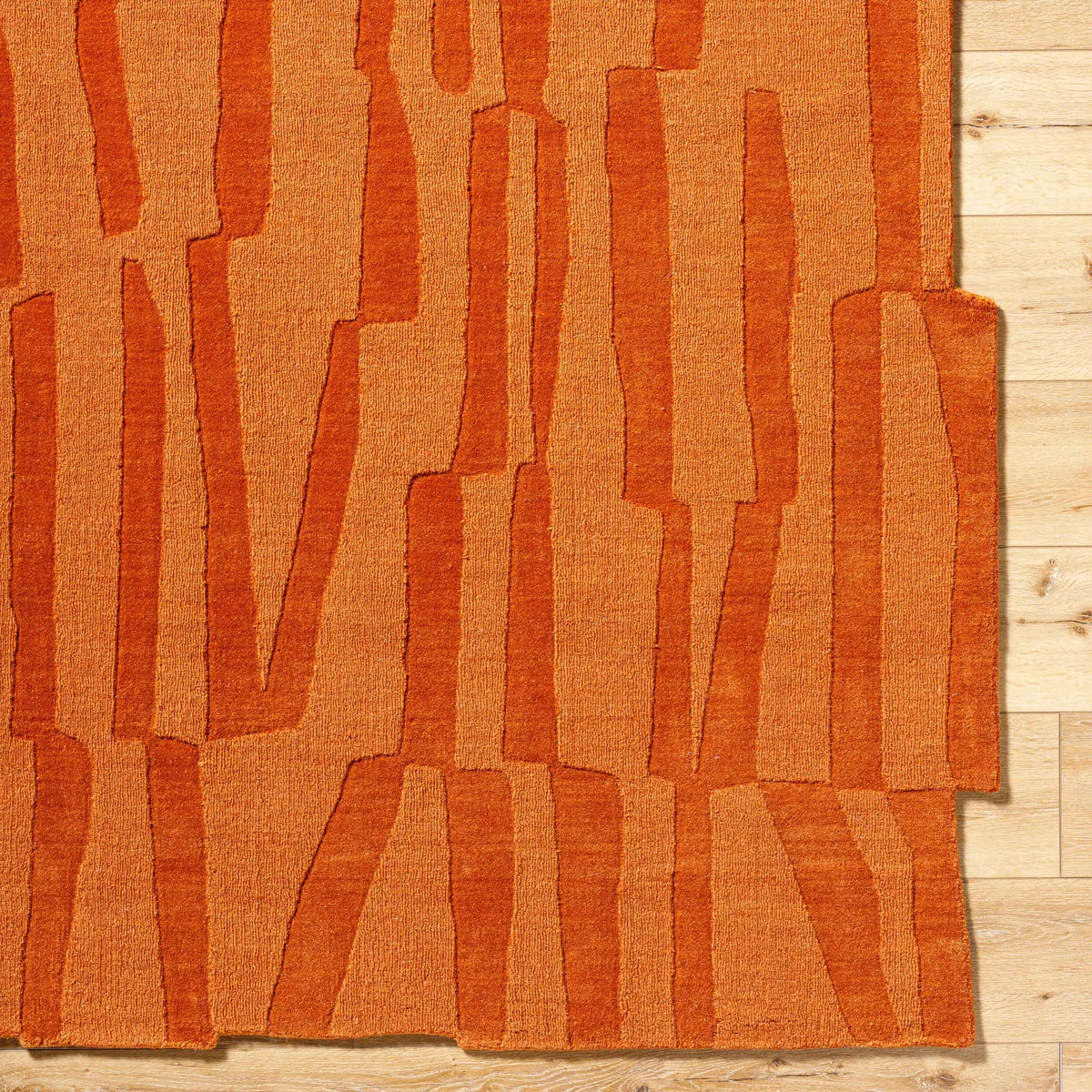 Livabliss Mystique M-5488 Burnt sienna hand-loomed wool area rug featuring abstract vertical stripes and artisan texture on light wood flooring.