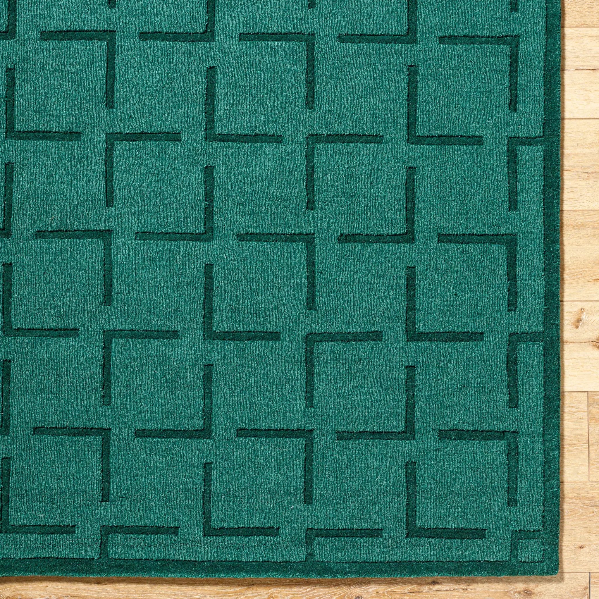 Livabliss Hand Loomed Mystique M-5490 Emerald Green wool area rug featuring a geometric L-shaped block pattern and medium pile texture on light wood flooring.