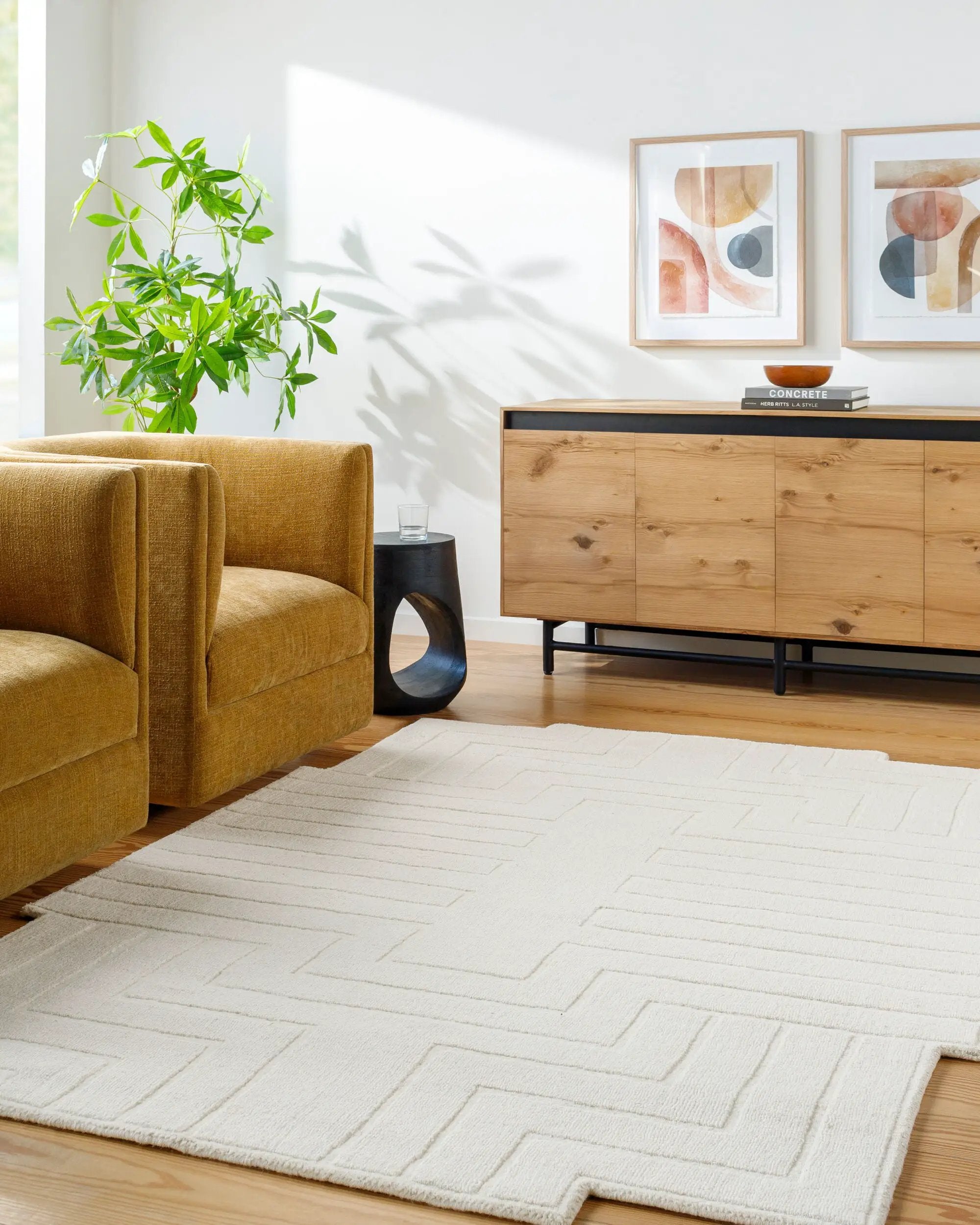 Livabliss Mystique M-5498 Ivory geometric hand-loomed wool area rug with a textured chevron pattern anchors a modern living room beside a mustard armchair and wooden sideboard.
