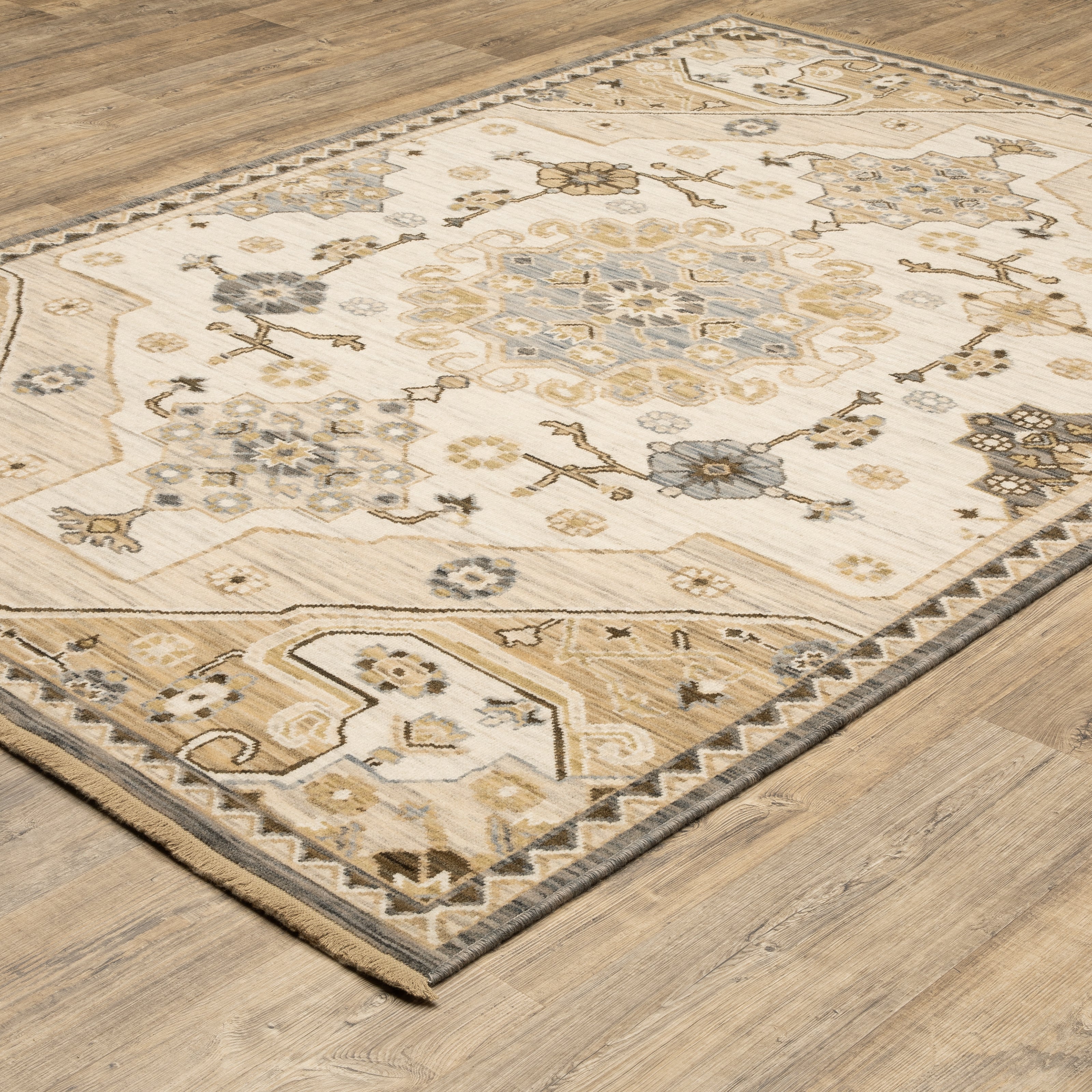 Acacia ACA03 Tan/Grey traditional area rug with earthy tan, grey, brown, gold, blue, clay, and green tones and cotton fringe.