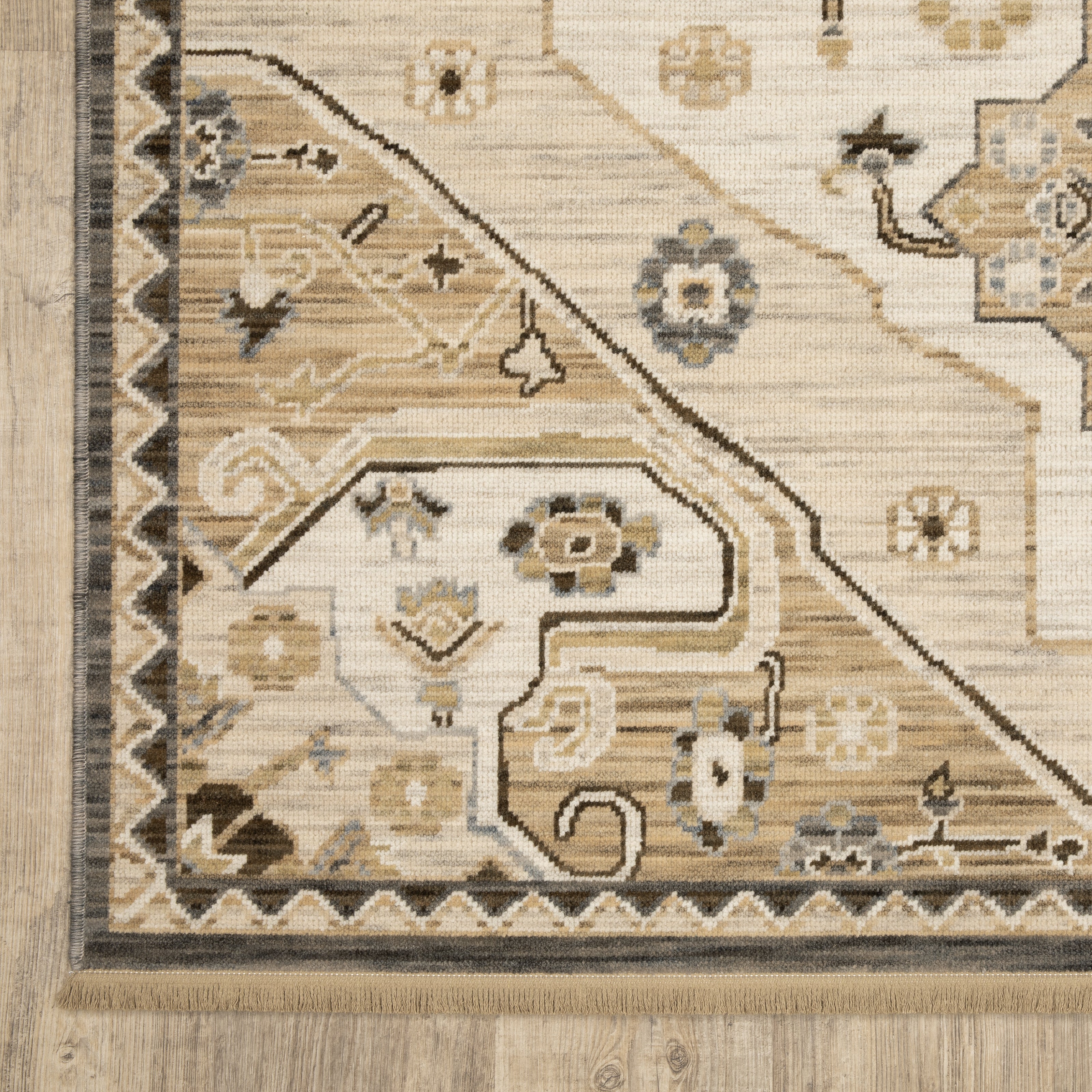 Acacia ACA03 Tan/Grey traditional area rug with earthy tan, grey, brown, gold, blue, clay, and green tones and cotton fringe.