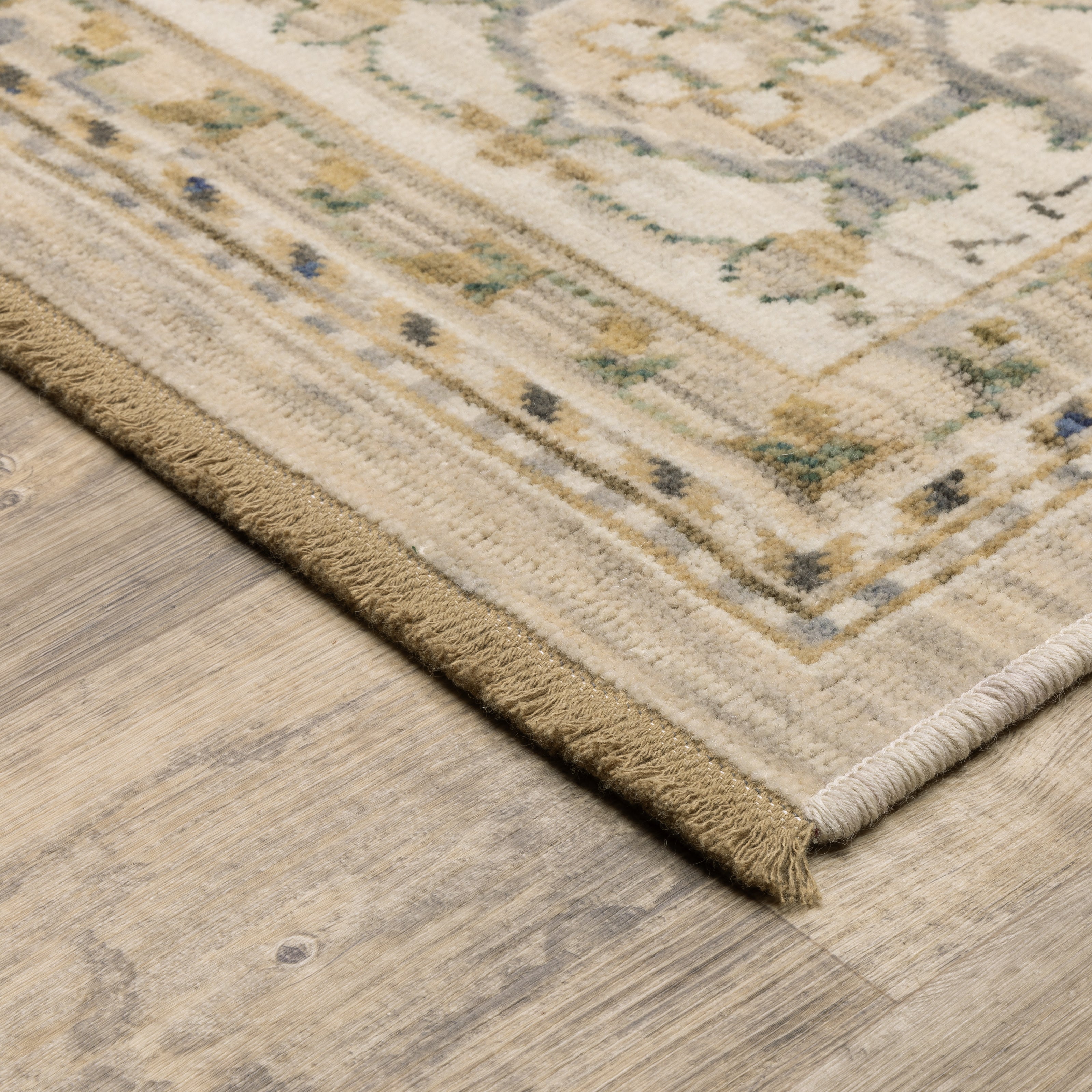 Acacia ACA07 Beige/Grey vintage-style area rug with soft neutral colors, traditional pattern detail, wool nylon texture, and cotton fringe.