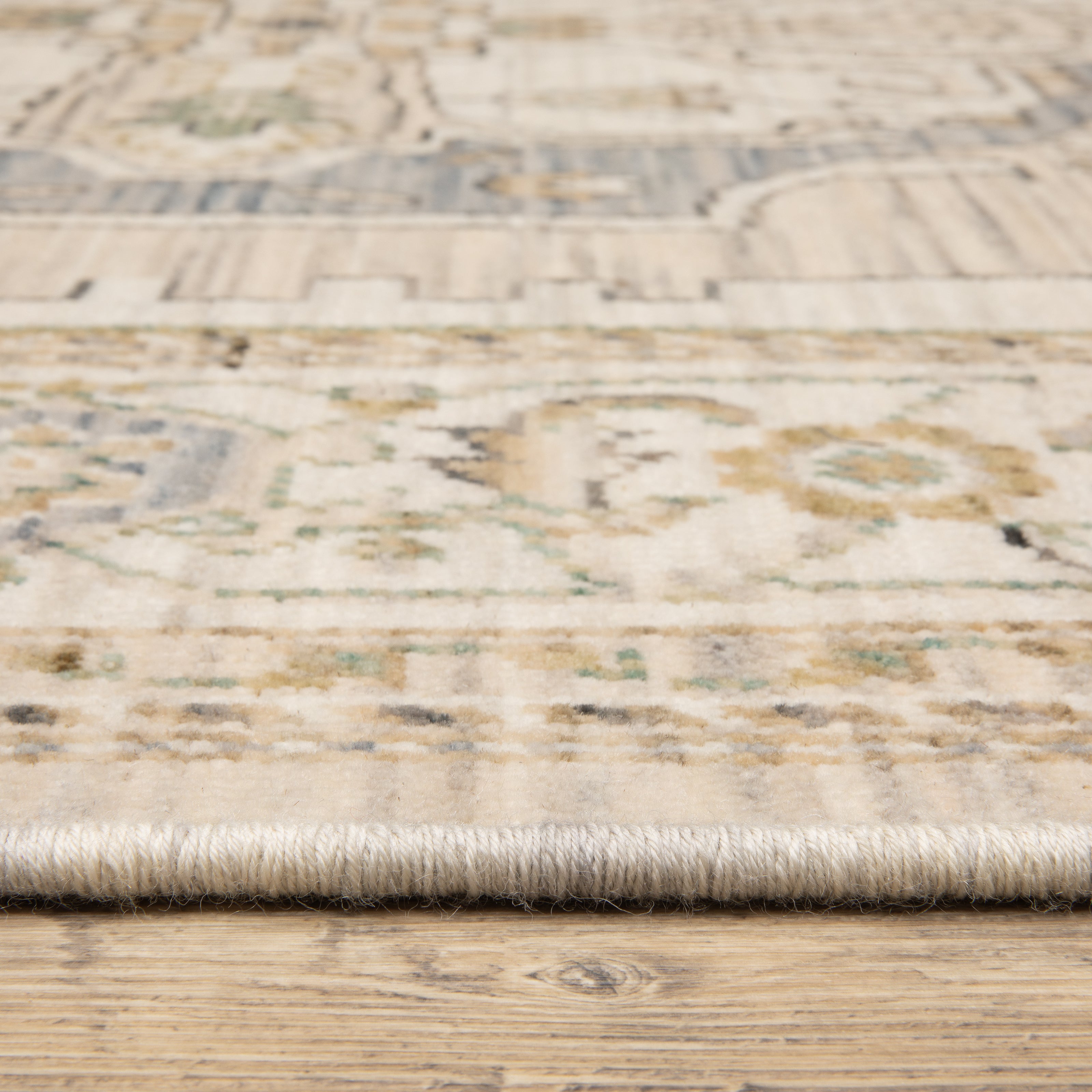 Acacia ACA07 Beige/Grey vintage-style area rug with soft neutral colors, traditional pattern detail, wool nylon texture, and cotton fringe.