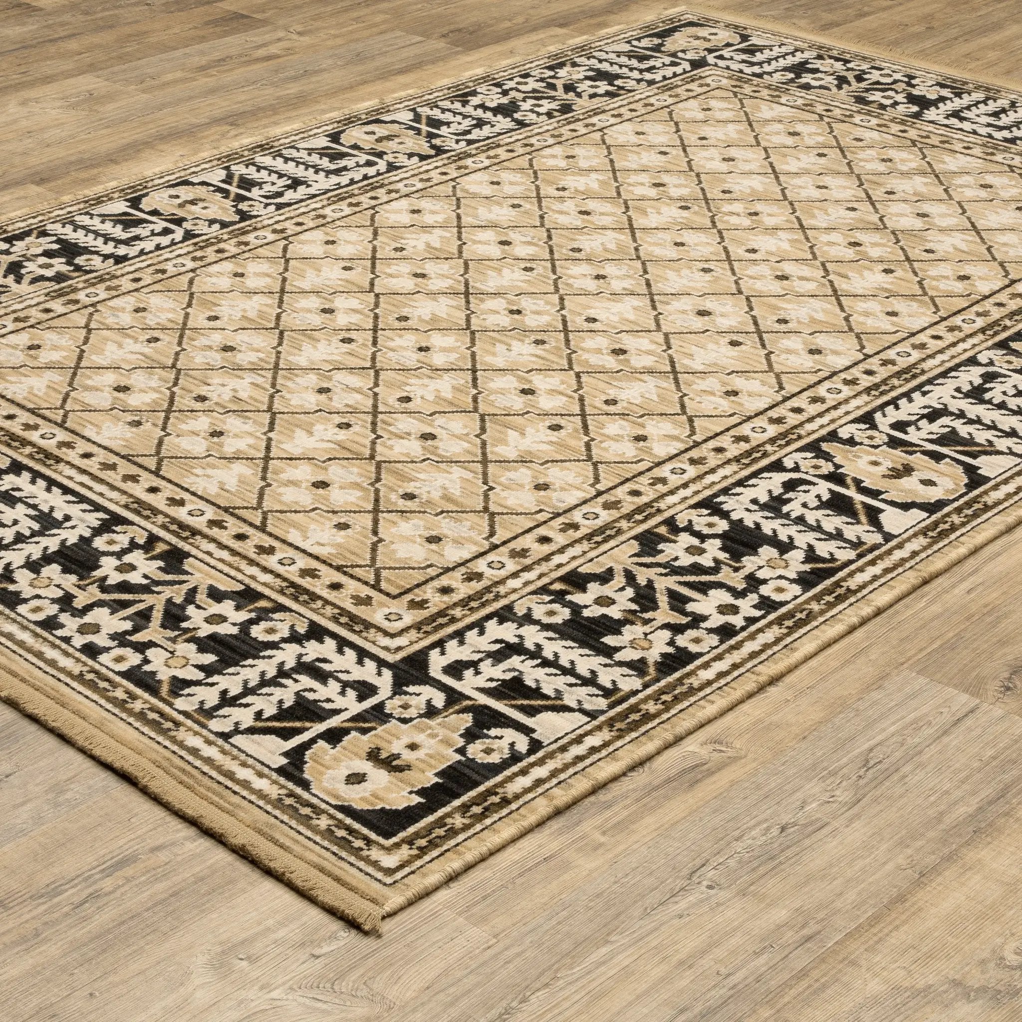 Acacia ACA12 Tan/Charcoal area rug with warm tan ground, charcoal contrast, traditional pattern detail, earthy accents, and cotton fringe.