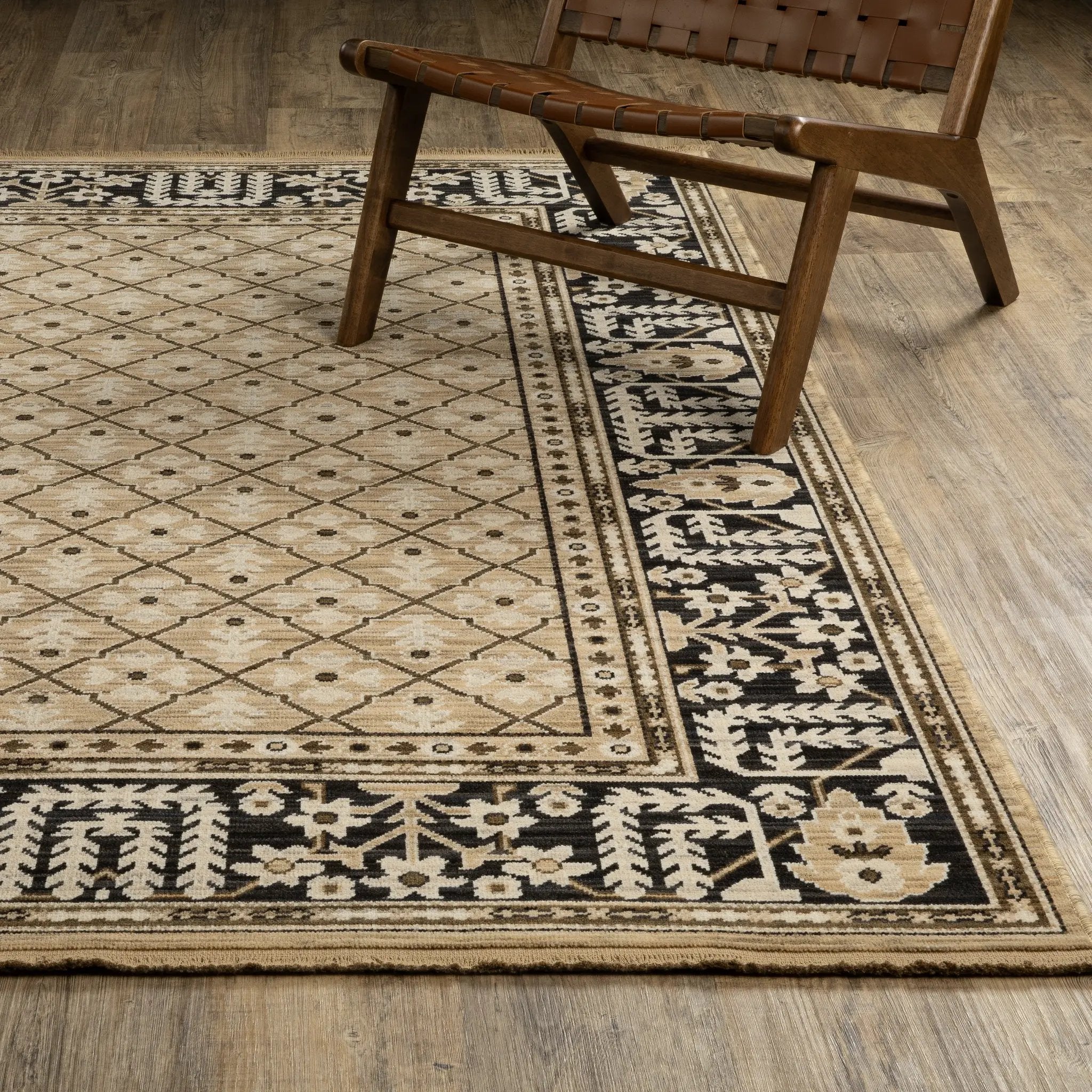 Acacia ACA12 Tan/Charcoal area rug with warm tan ground, charcoal contrast, traditional pattern detail, earthy accents, and cotton fringe.
