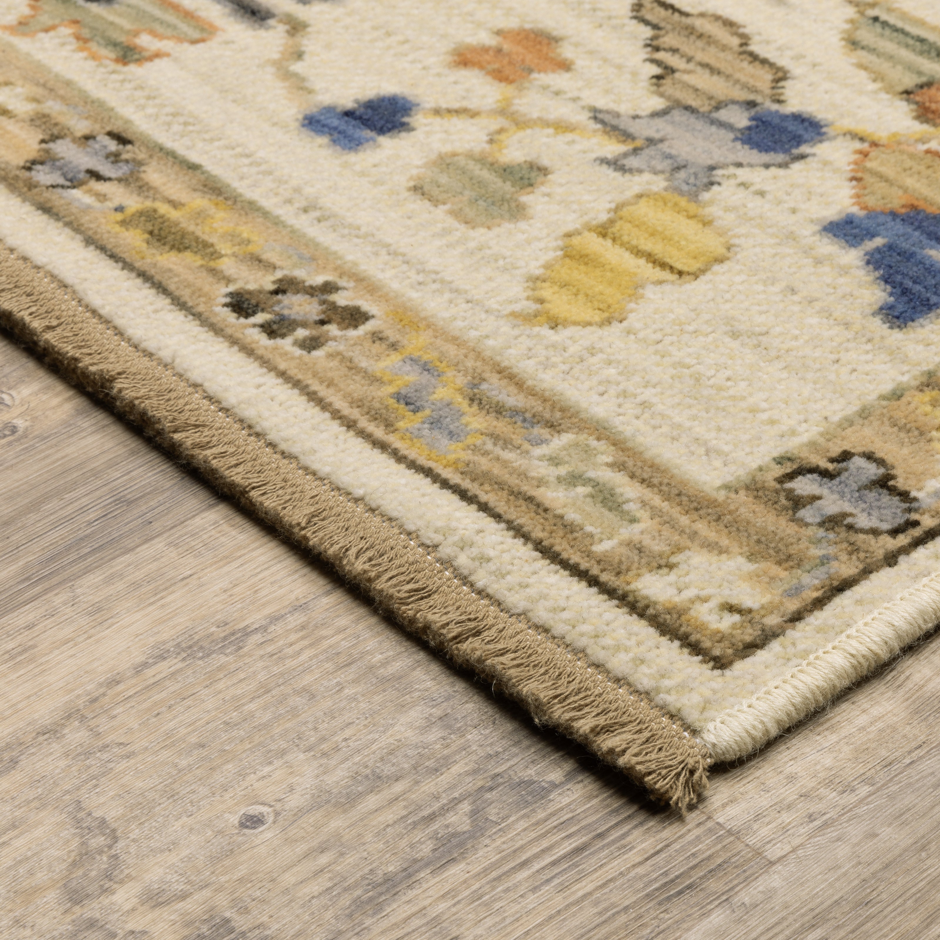 Acacia ACA13 Beige/Tan neutral traditional area rug with warm beige and tan tones, vintage-style pattern, wool nylon blend, and fringe.