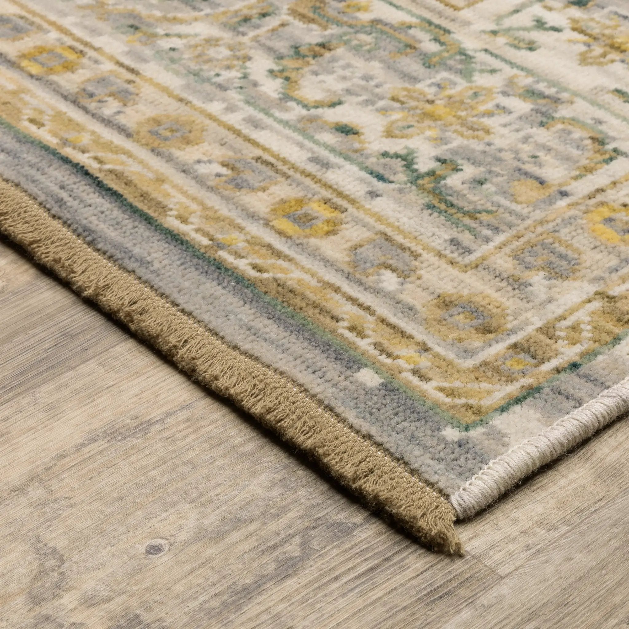 Acacia ACA14 Beige/Green nature-inspired traditional area rug with soft beige and green palette, warm accent colors, and cotton fringe.