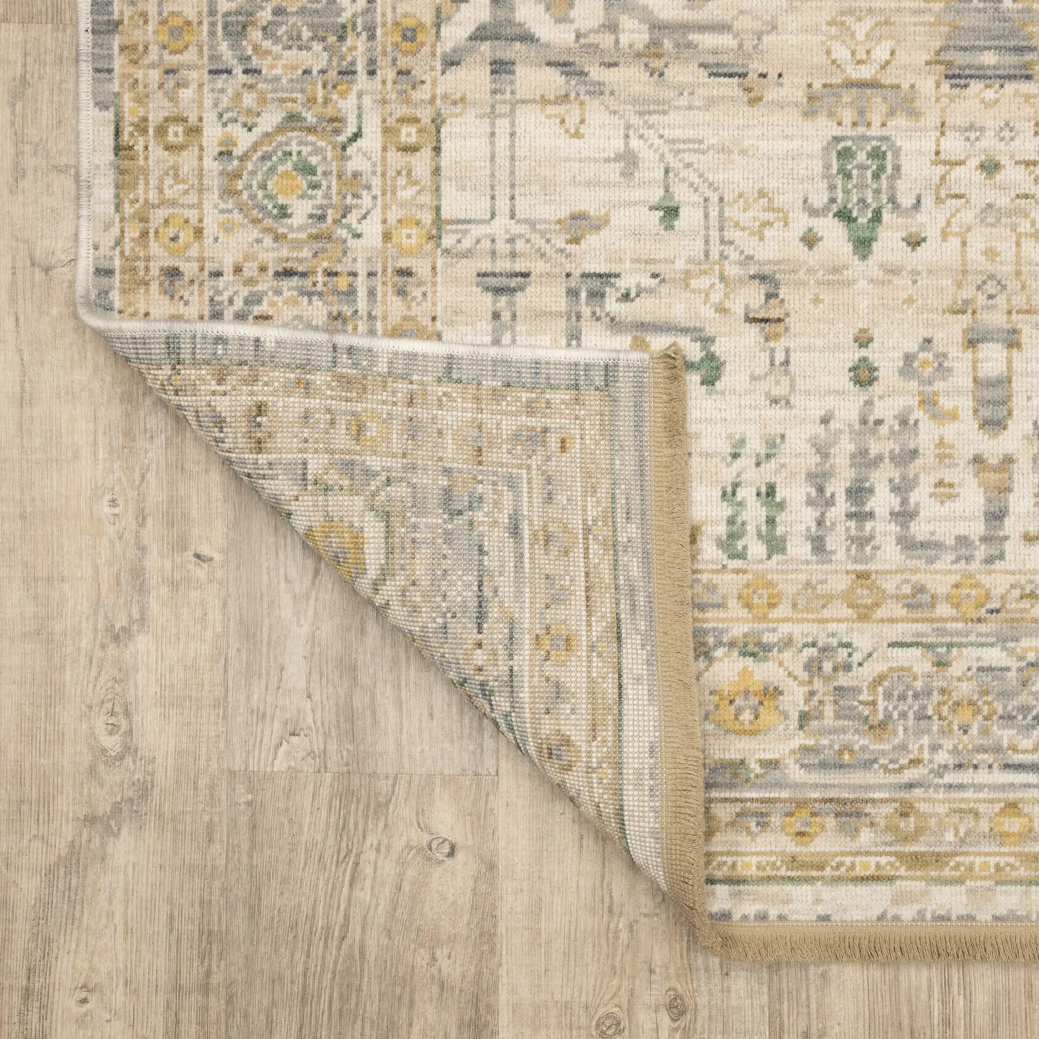 Acacia ACA14 Beige/Green nature-inspired traditional area rug with soft beige and green palette, warm accent colors, and cotton fringe.