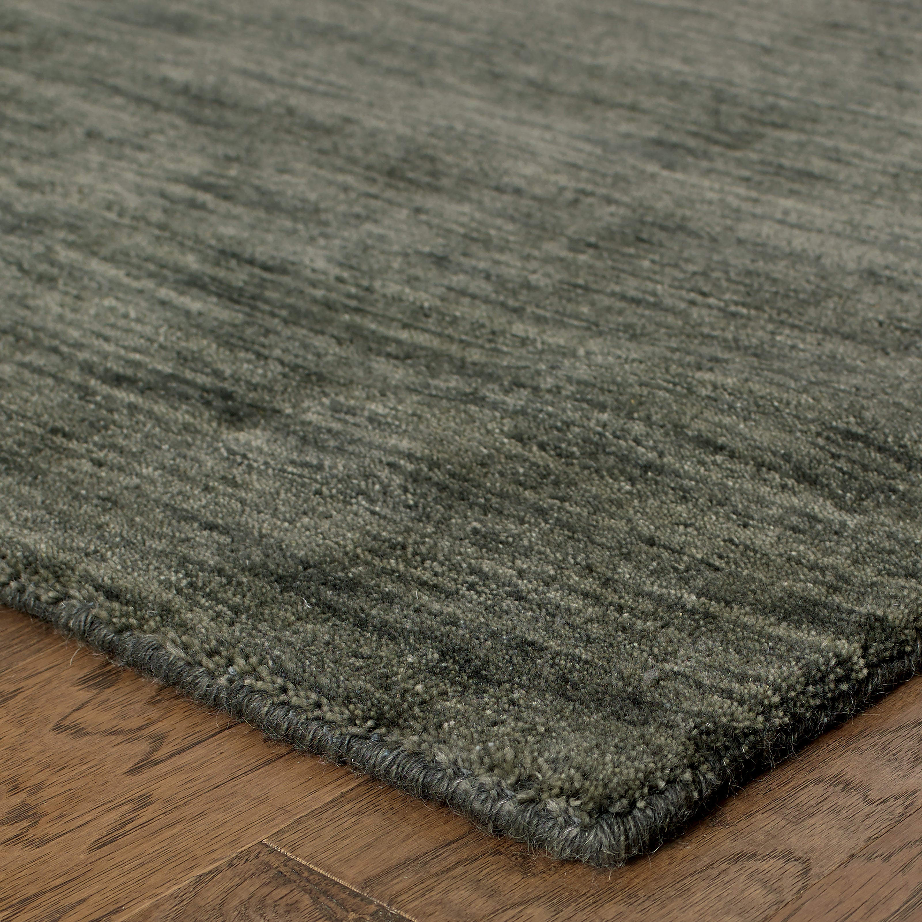 Aniston 27102 Charcoal Area Rug, charcoal solid wool area rug with heathered texture and tailored handwoven surface.