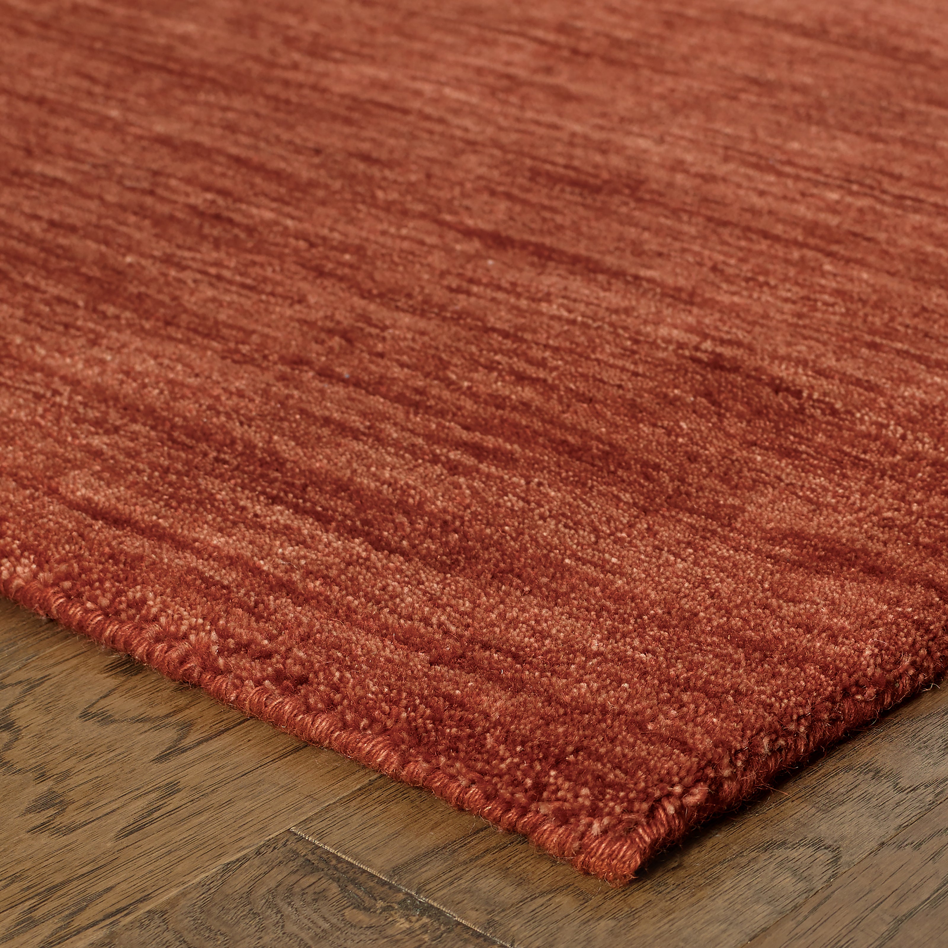 Aniston 27103 Rust Area Rug, rust solid wool area rug with heathered texture and warm handwoven surface.