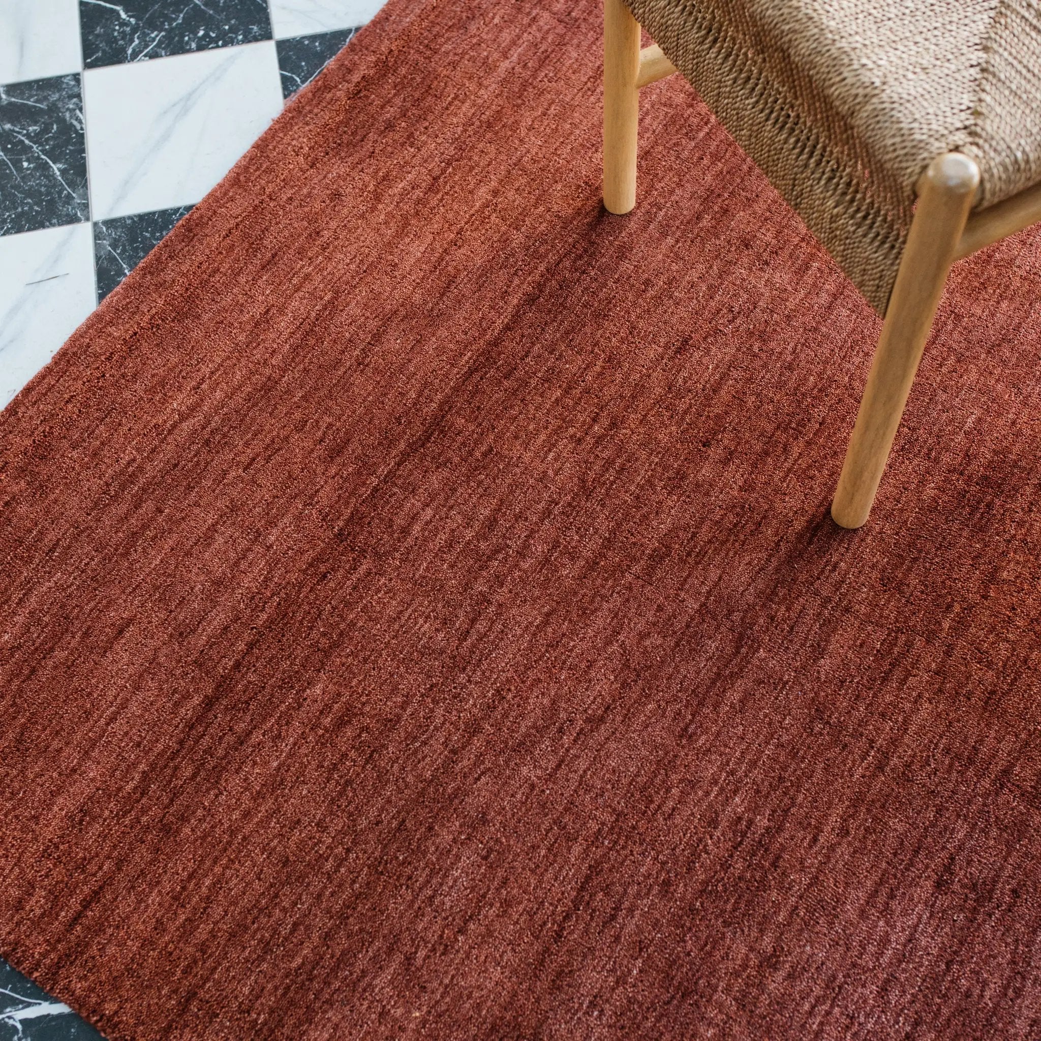 Aniston 27103 Rust Area Rug, rust solid wool area rug with heathered texture and warm handwoven surface.