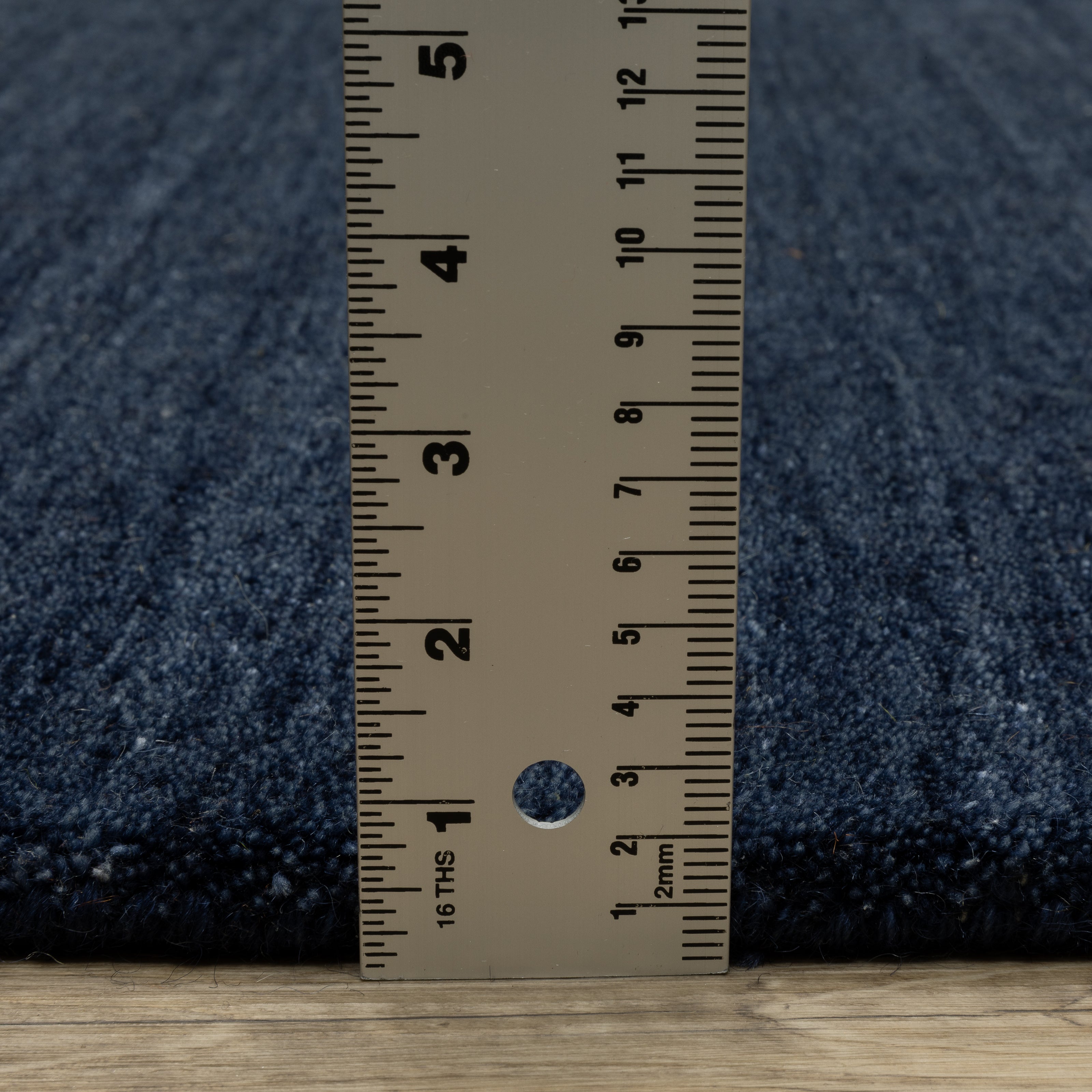 Aniston II 27119 Navy Area Rug, navy solid wool area rug with heathered texture and plush hand-tufted surface.