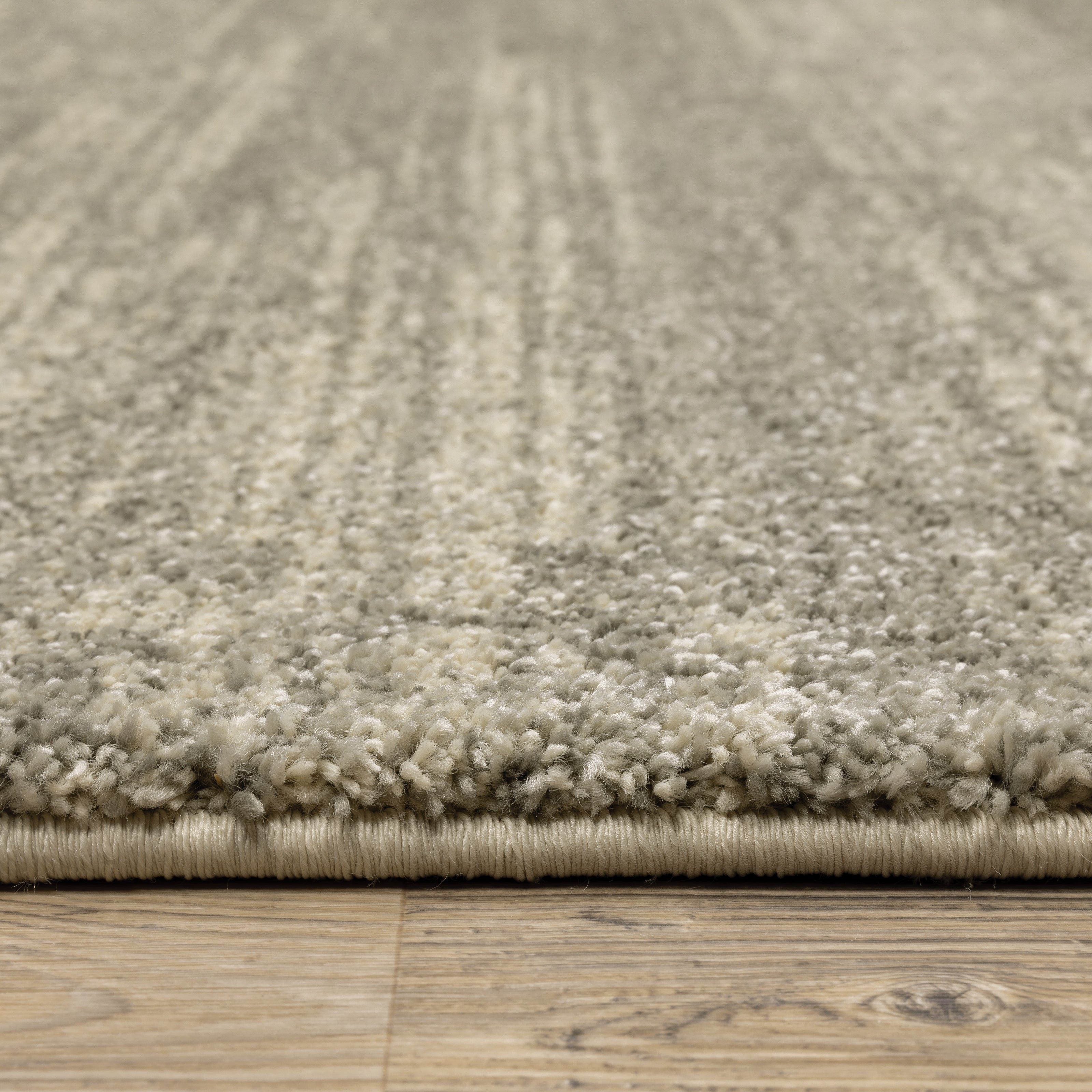 Oriental Weavers Astor 5572E plush modern rug featuring abstract pattern in grey/ beige tones