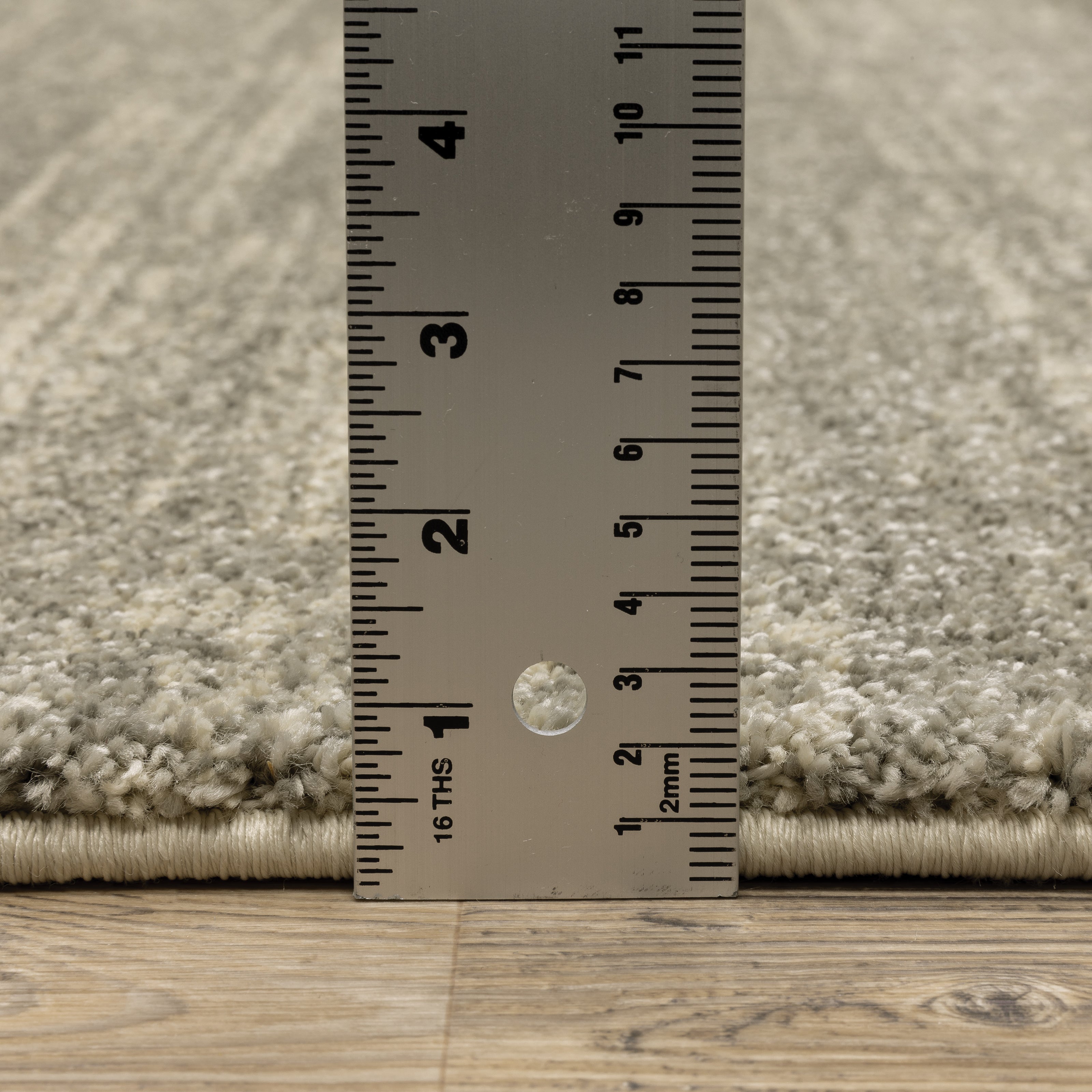Oriental Weavers Astor 5572E plush modern rug featuring abstract pattern in grey/ beige tones